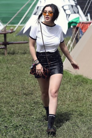 Charlie XCX wearing Coach attends the Glastonbury Festival