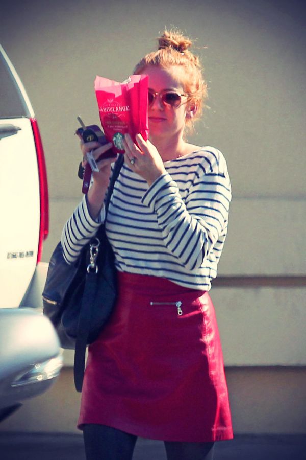 Isla Fisher heads out of a Starbucks LA