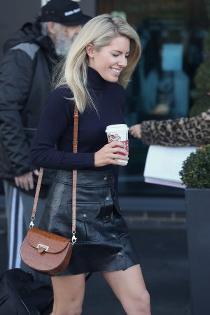 Mollie King seen leaving her hotel with a coffee