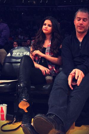 Selena Gomez sits courtside while watching the Los Angeles Lakers