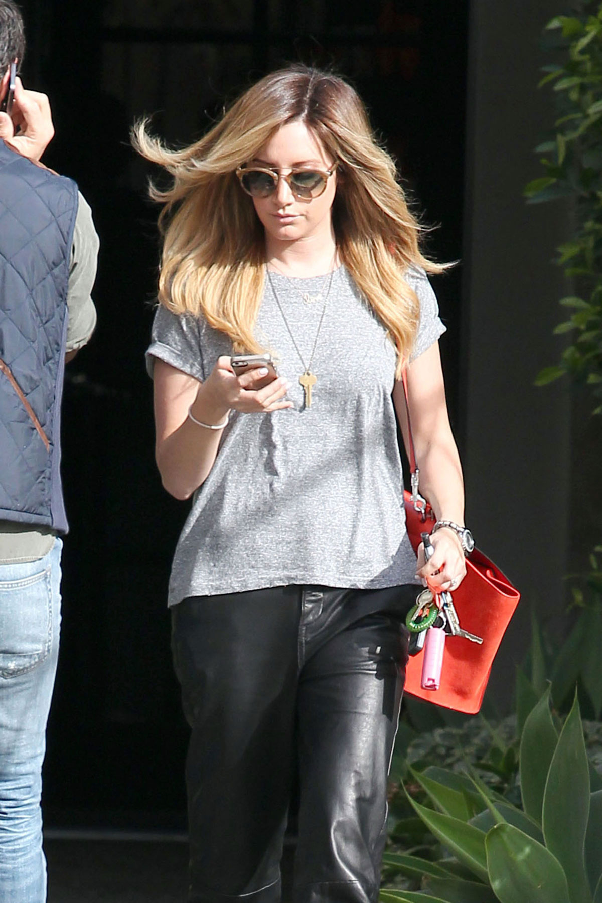 Ashley Tisdale checks out her iPhone as she runs errands around