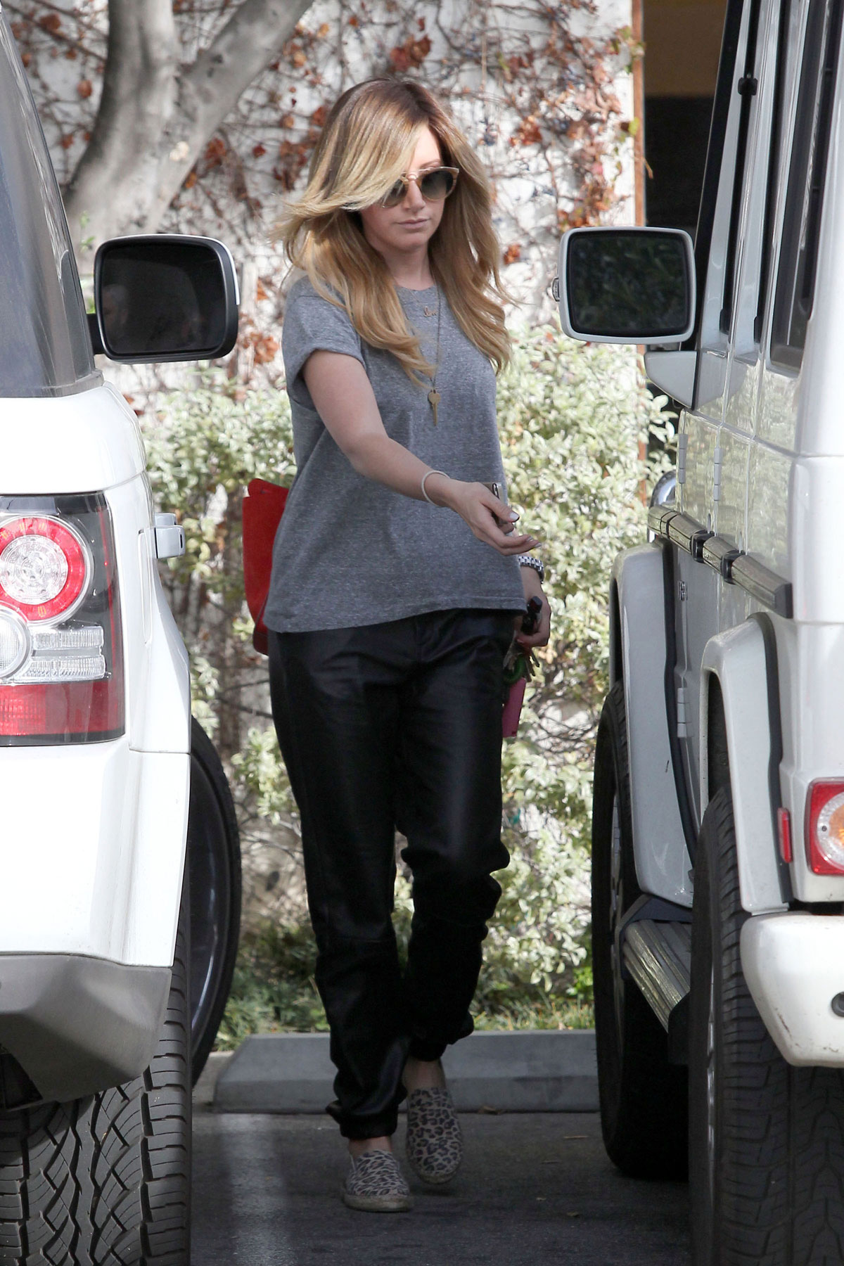 Ashley Tisdale checks out her iPhone as she runs errands around