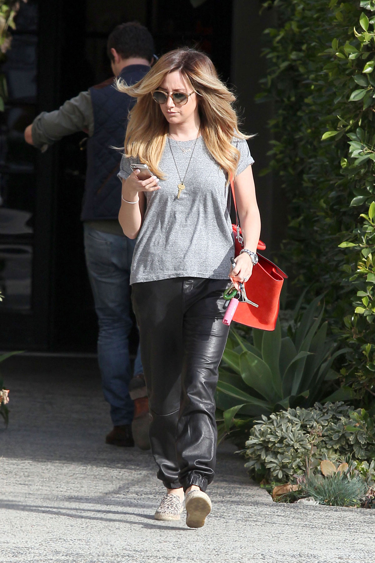 Ashley Tisdale checks out her iPhone as she runs errands around