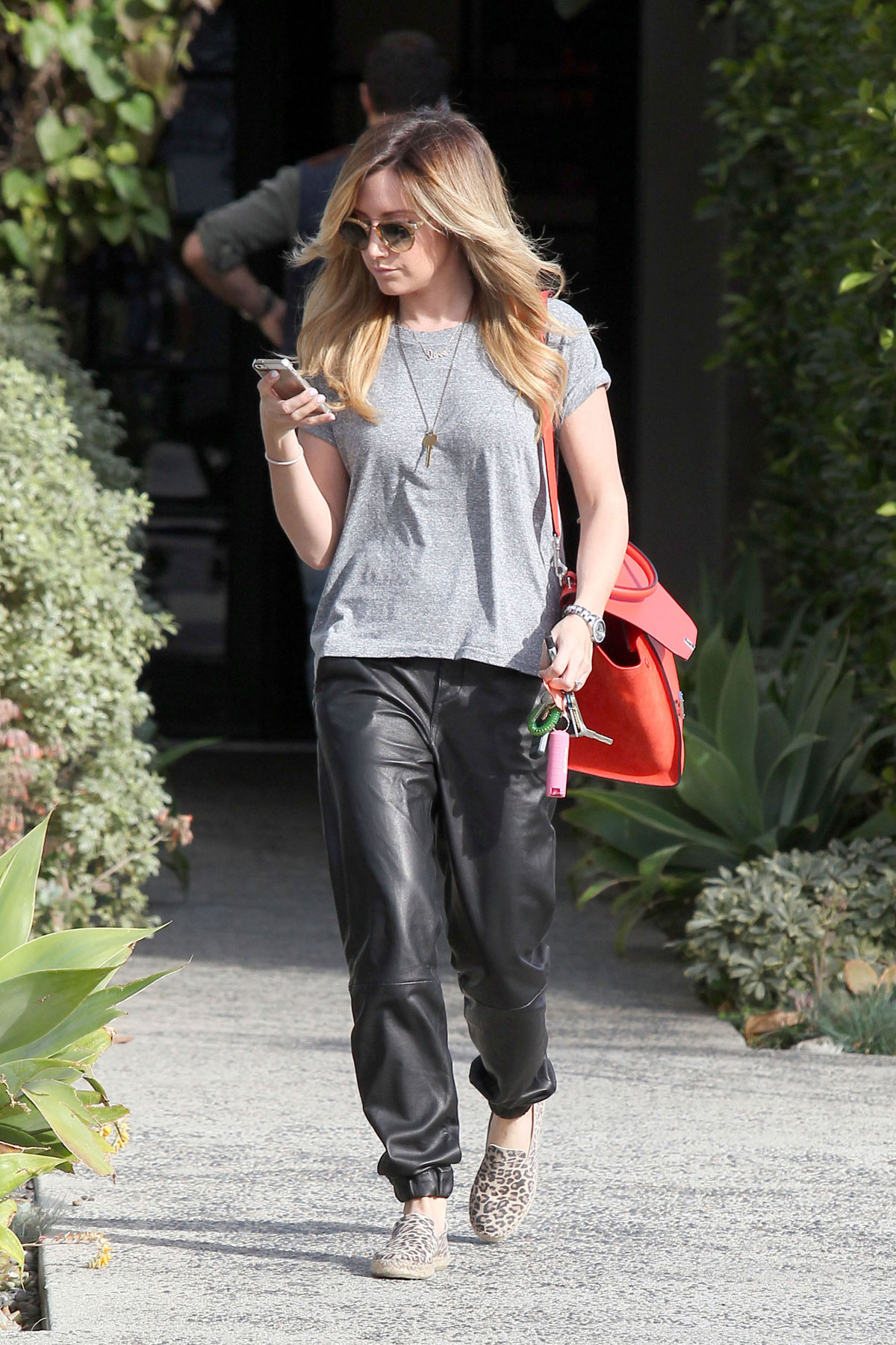 Ashley Tisdale checks out her iPhone as she runs errands around