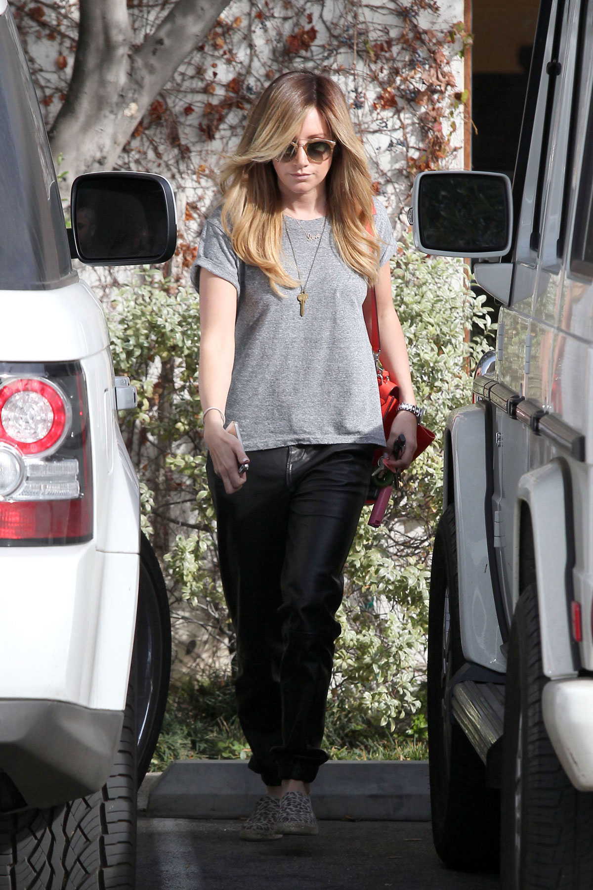 Ashley Tisdale checks out her iPhone as she runs errands around