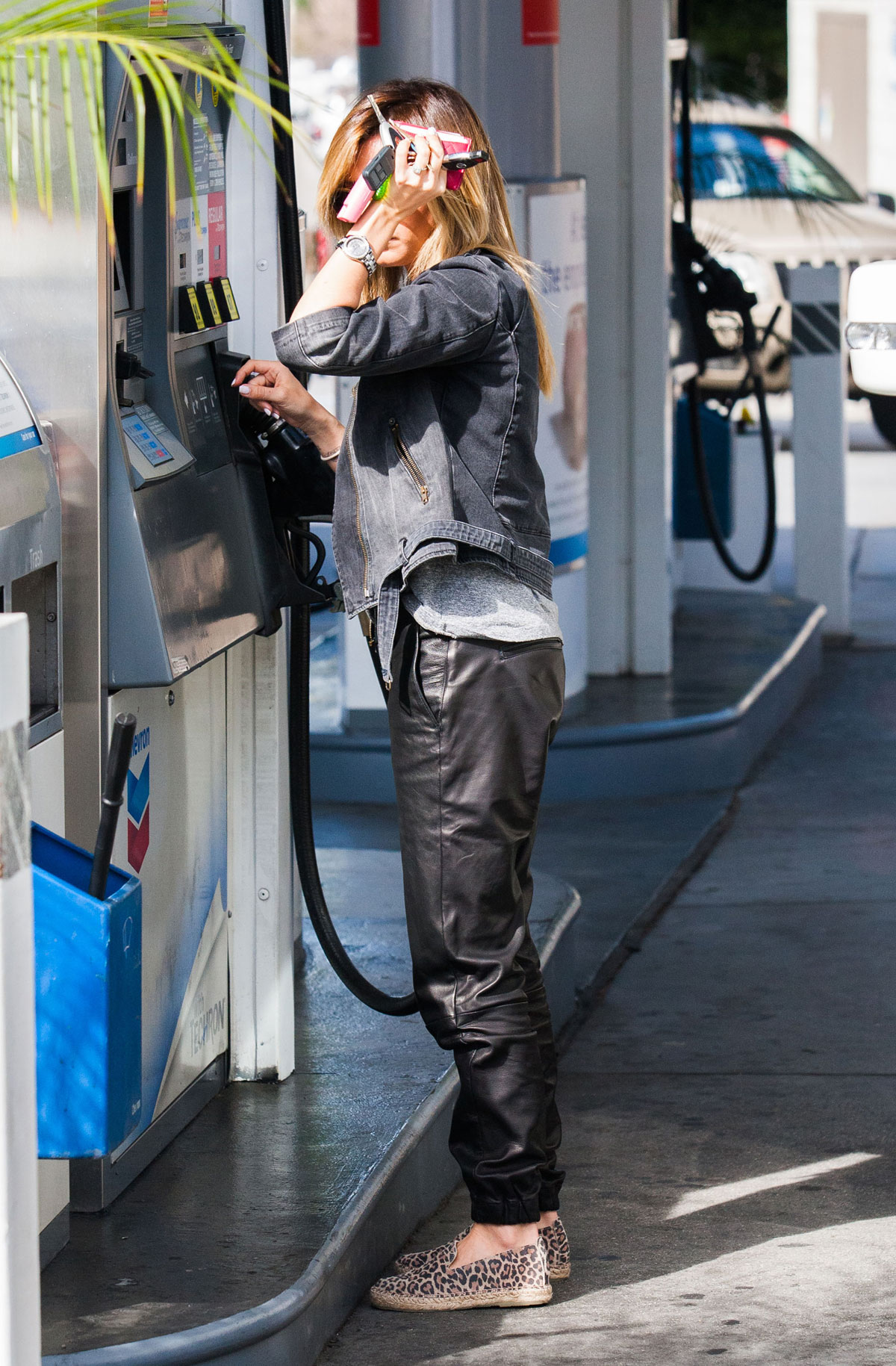 Ashley Tisdale checks out her iPhone as she runs errands around