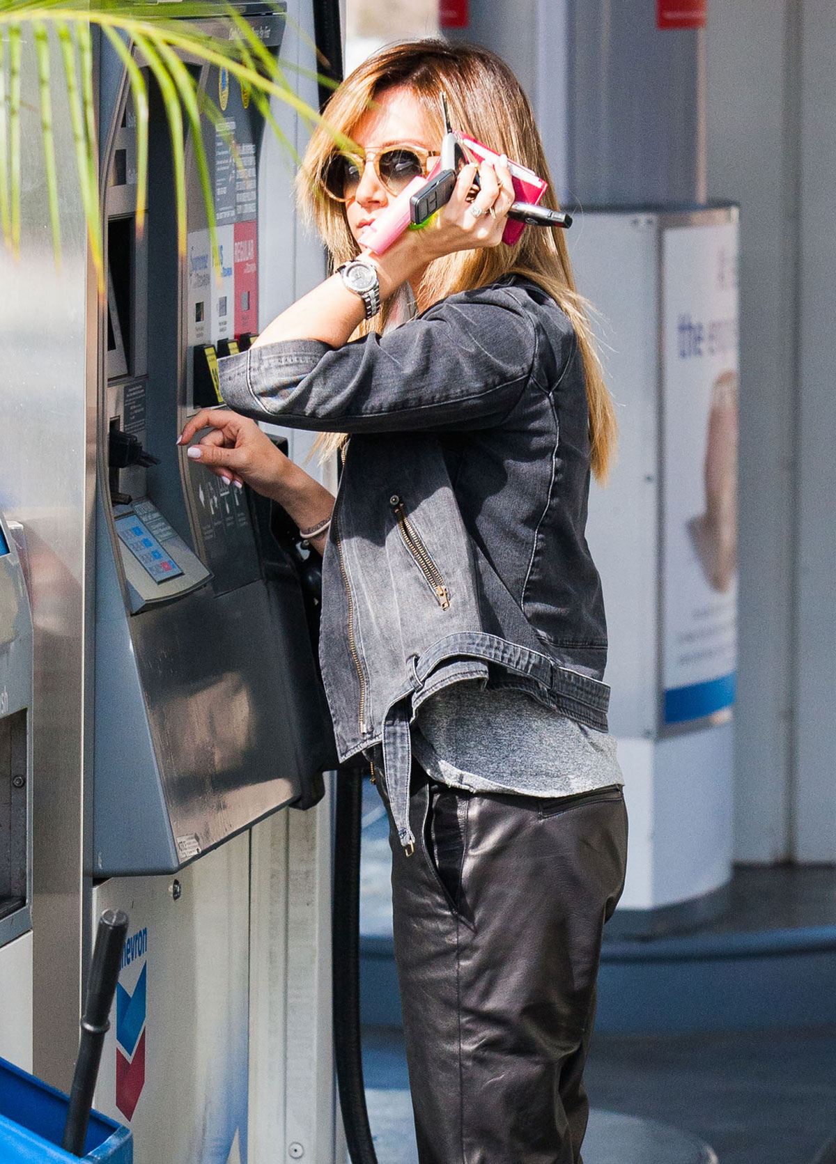 Ashley Tisdale checks out her iPhone as she runs errands around