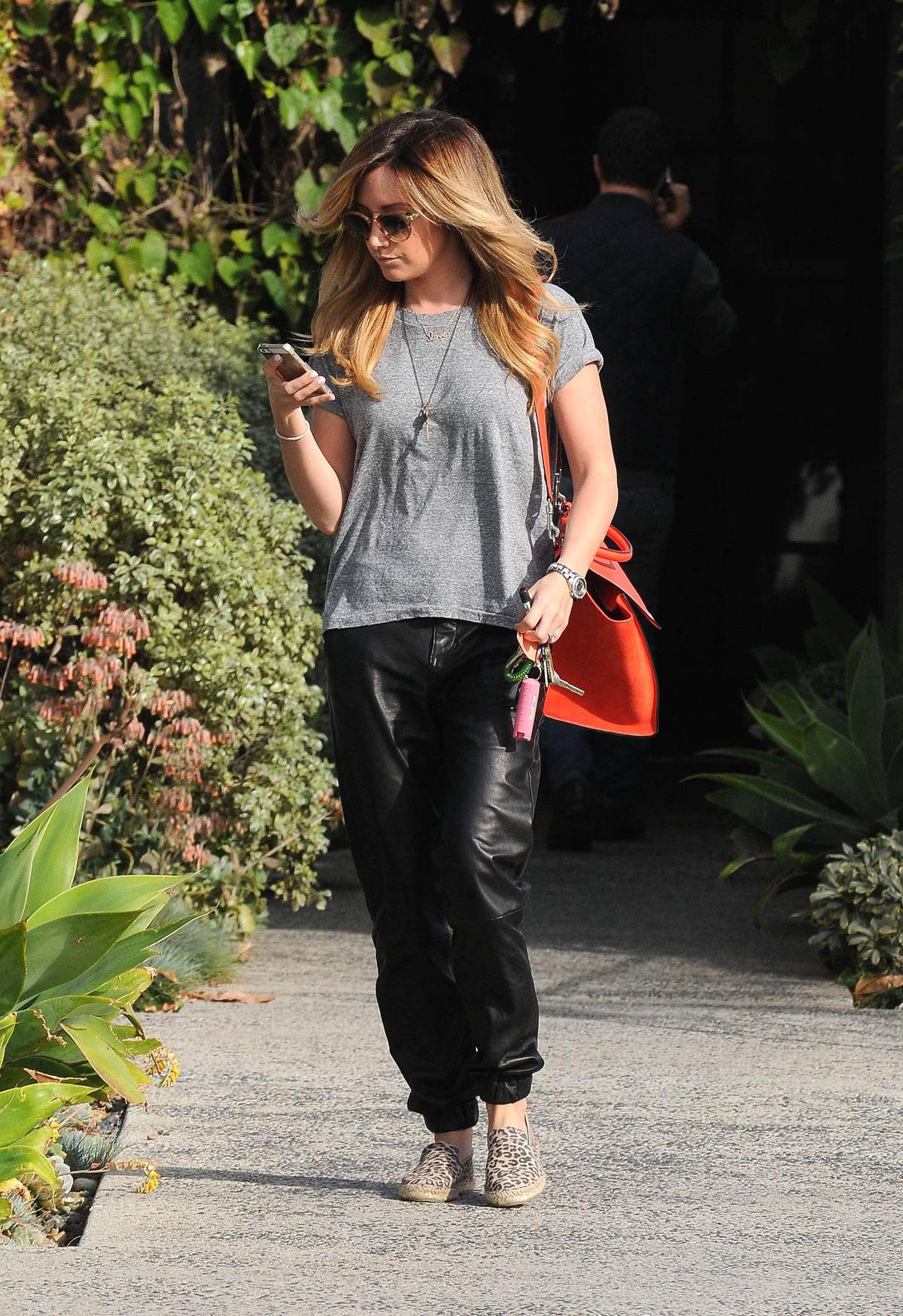 Ashley Tisdale checks out her iPhone as she runs errands around