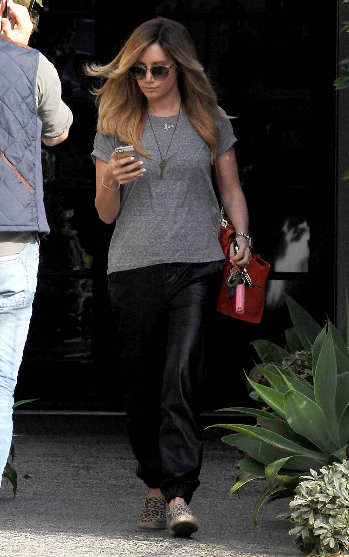 Ashley Tisdale checks out her iPhone as she runs errands around