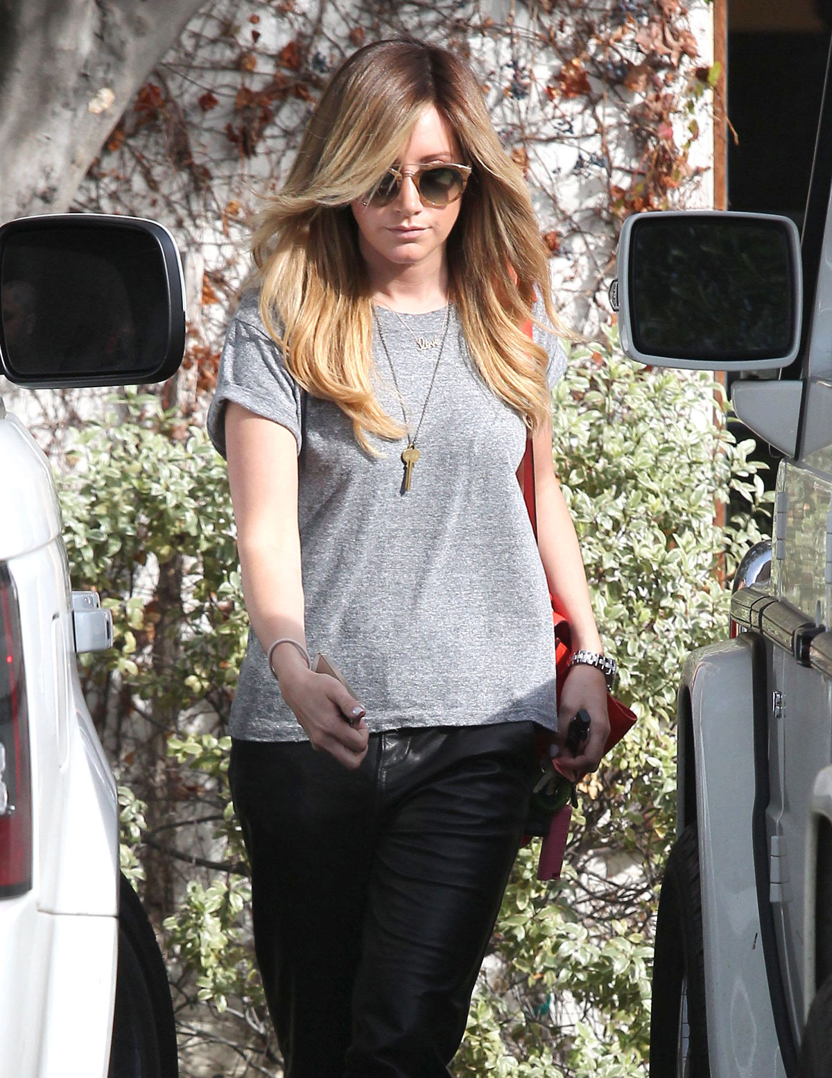 Ashley Tisdale checks out her iPhone as she runs errands around