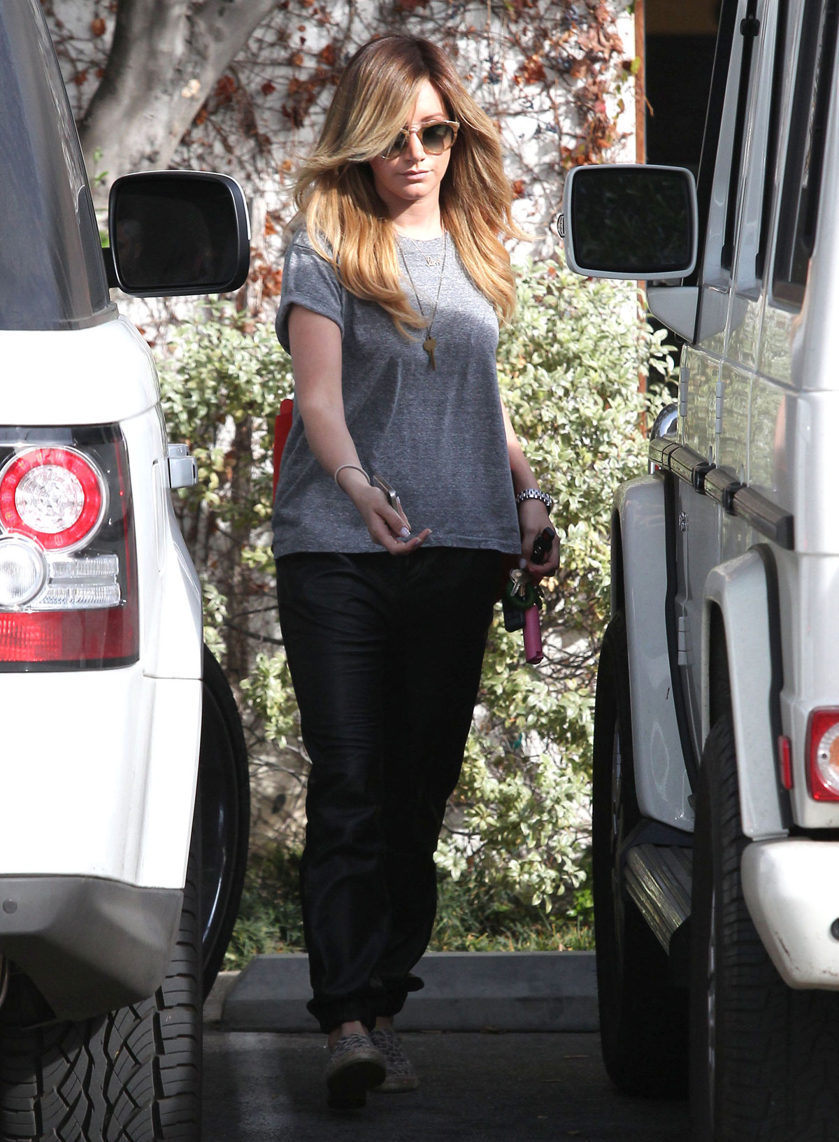 Ashley Tisdale checks out her iPhone as she runs errands around