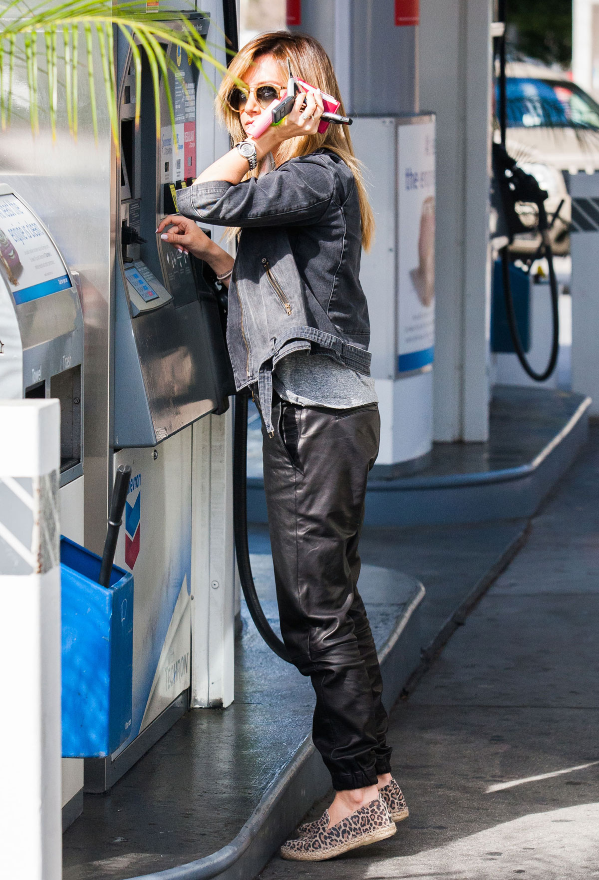 Ashley Tisdale checks out her iPhone as she runs errands around