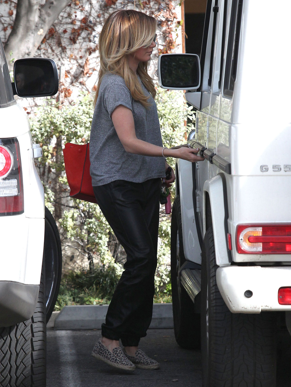 Ashley Tisdale checks out her iPhone as she runs errands around