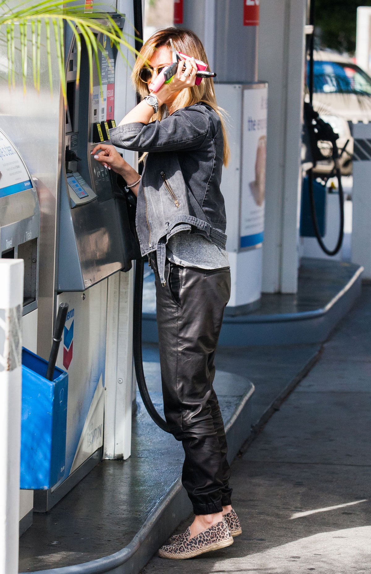 Ashley Tisdale checks out her iPhone as she runs errands around