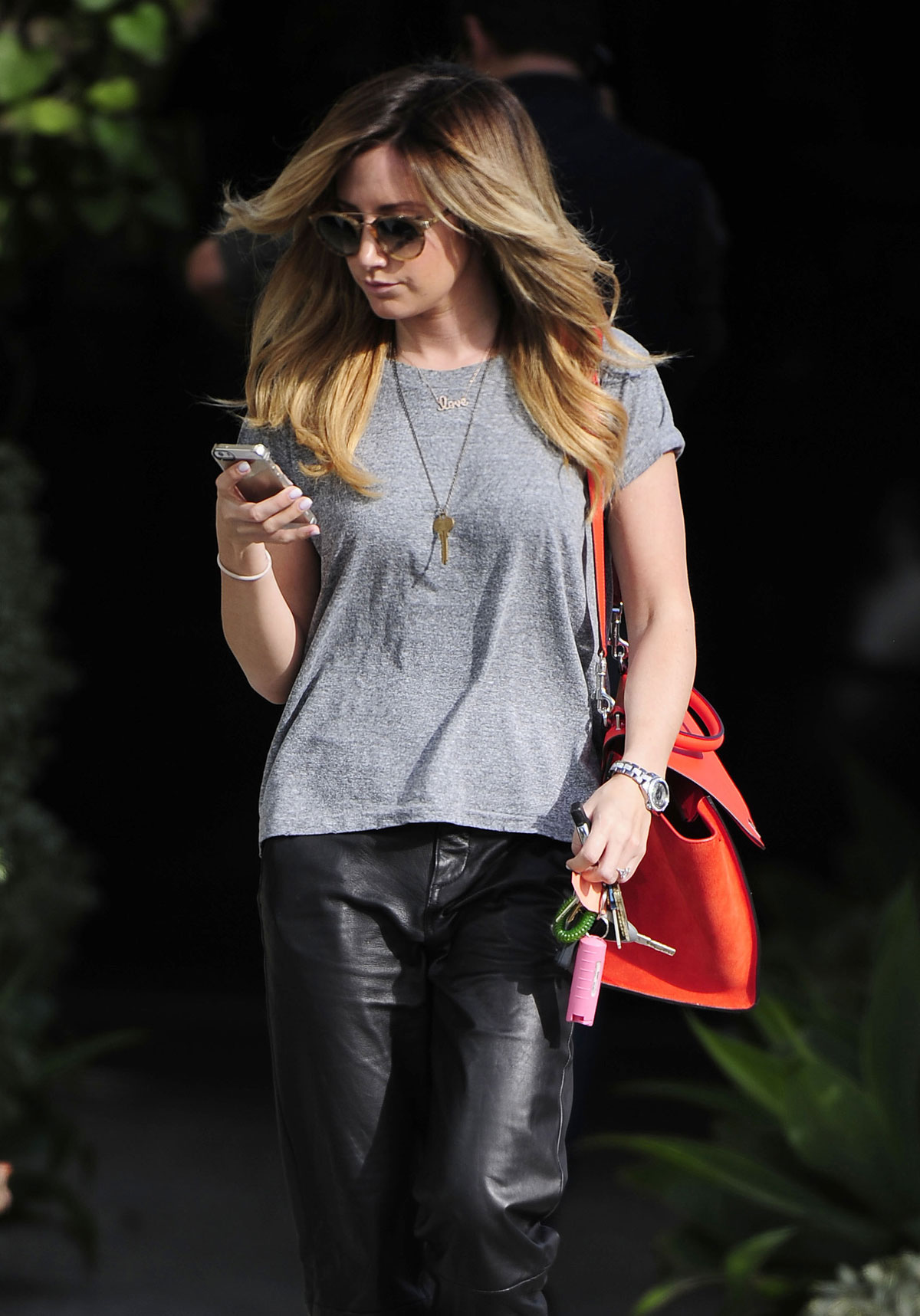 Ashley Tisdale checks out her iPhone as she runs errands around