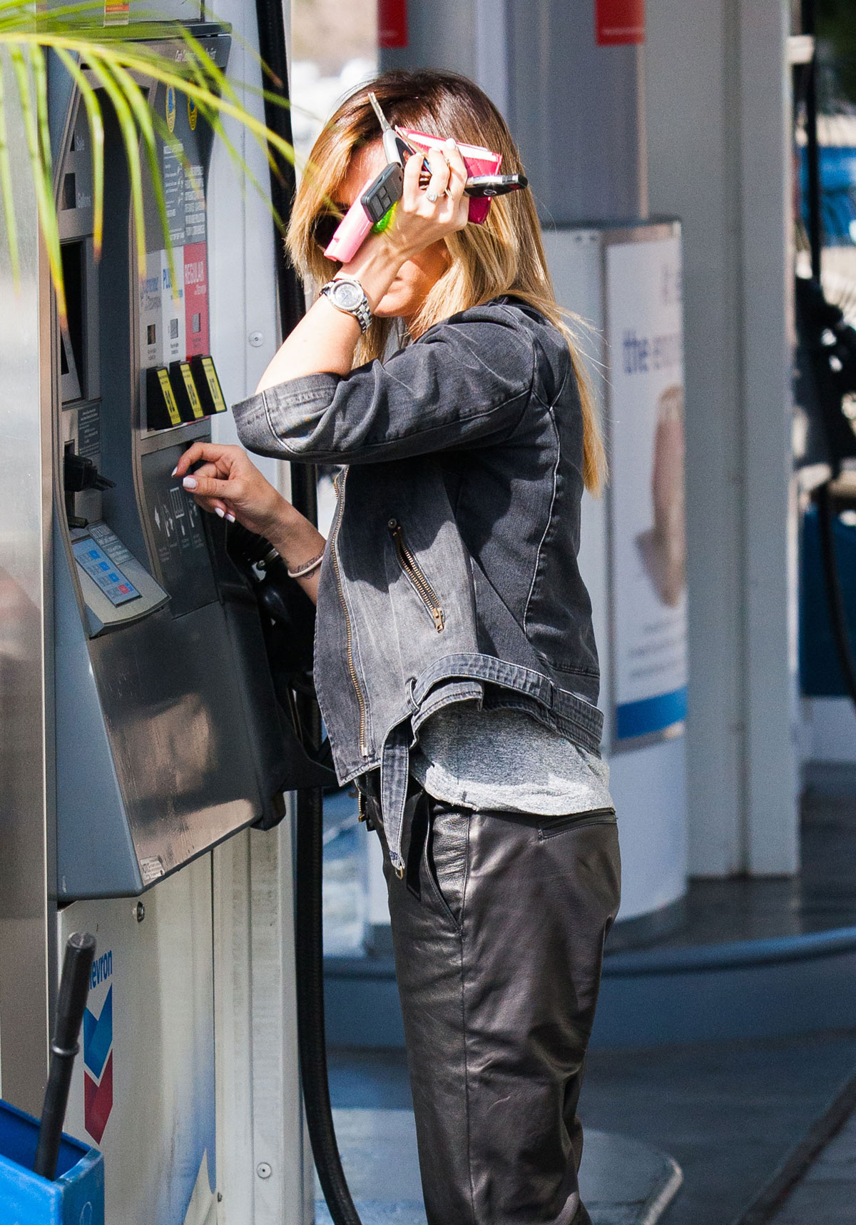 Ashley Tisdale checks out her iPhone as she runs errands around