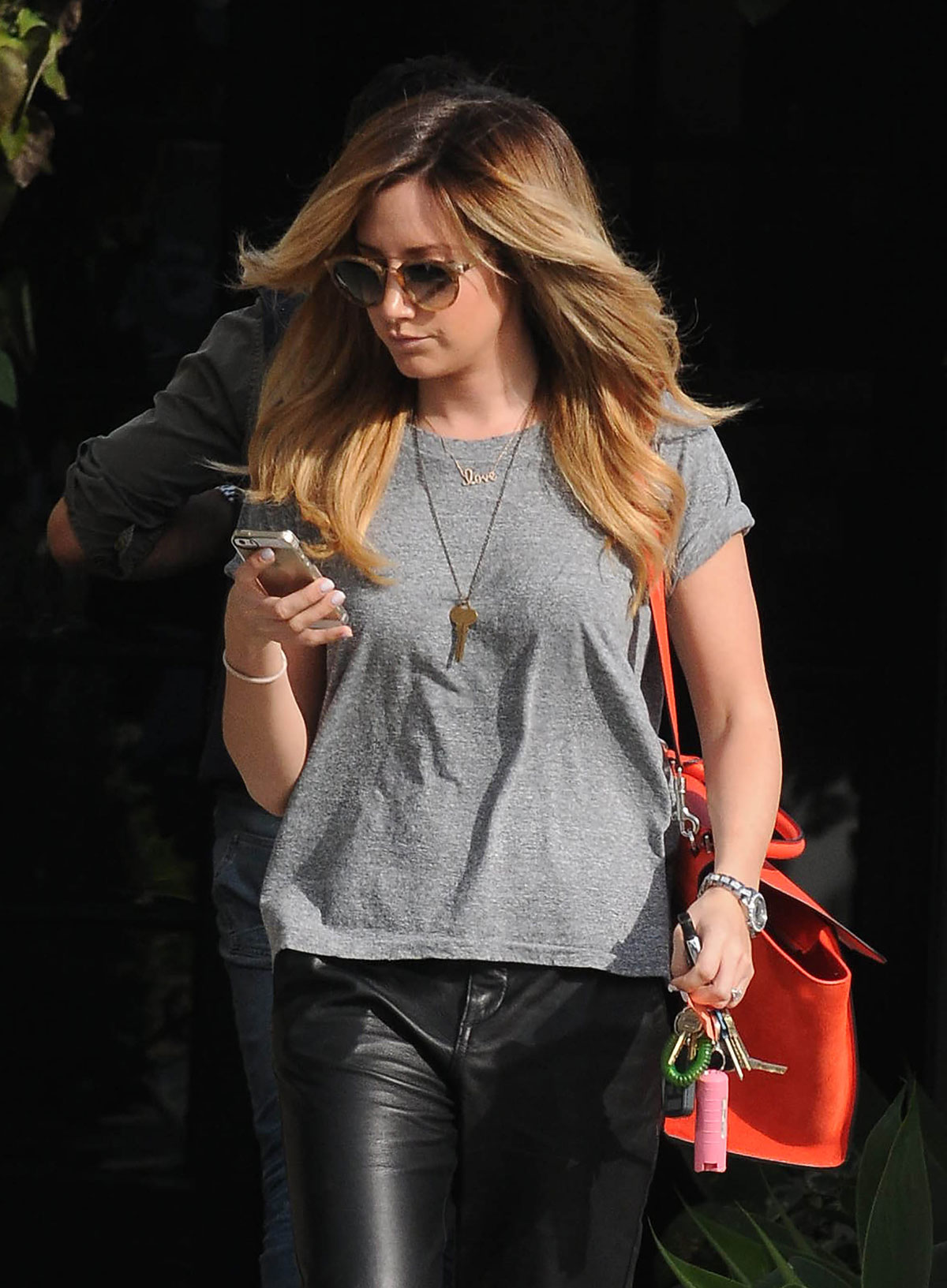 Ashley Tisdale checks out her iPhone as she runs errands around