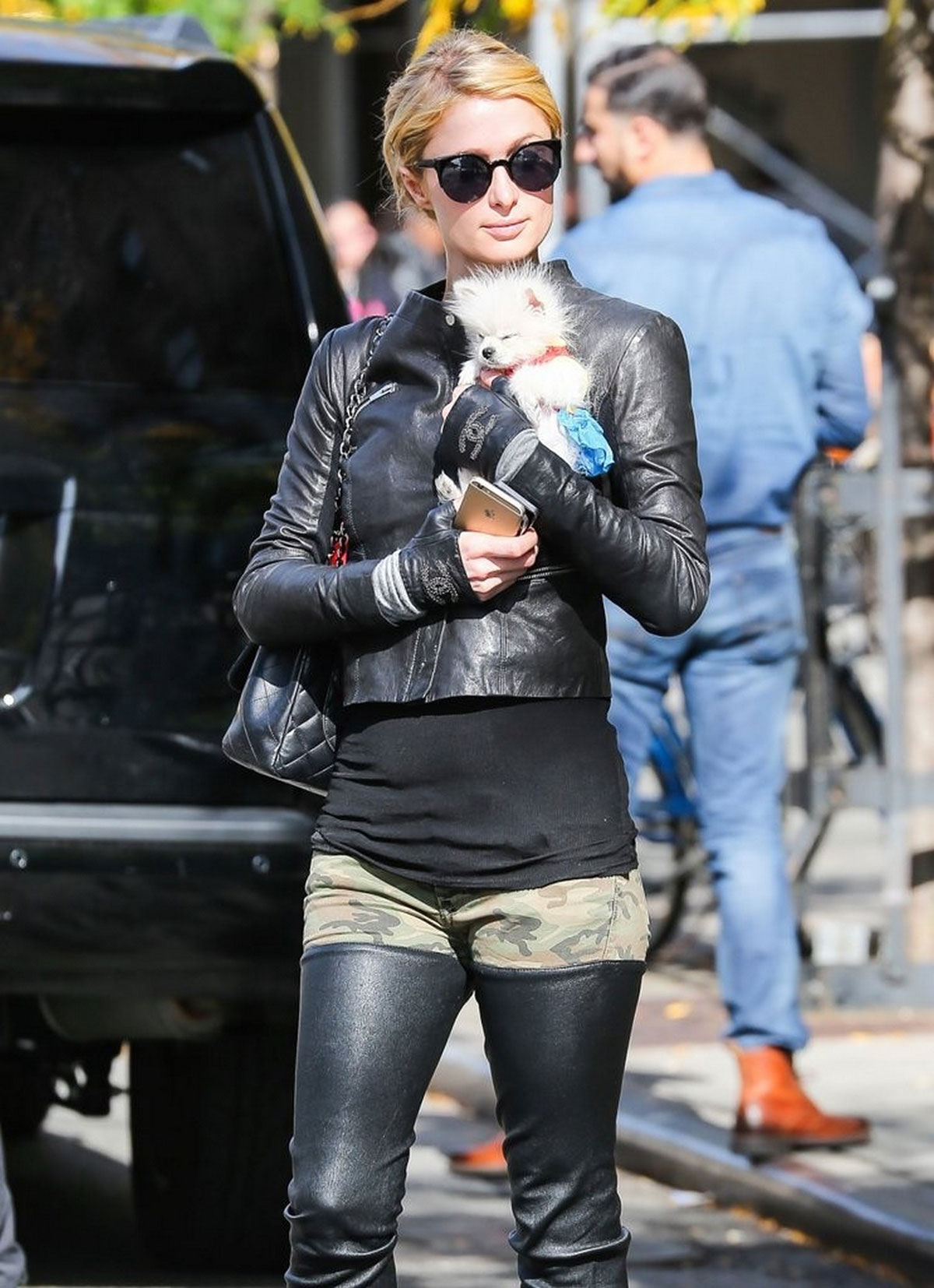 Paris Hilton seen with her dog waiting for a cab