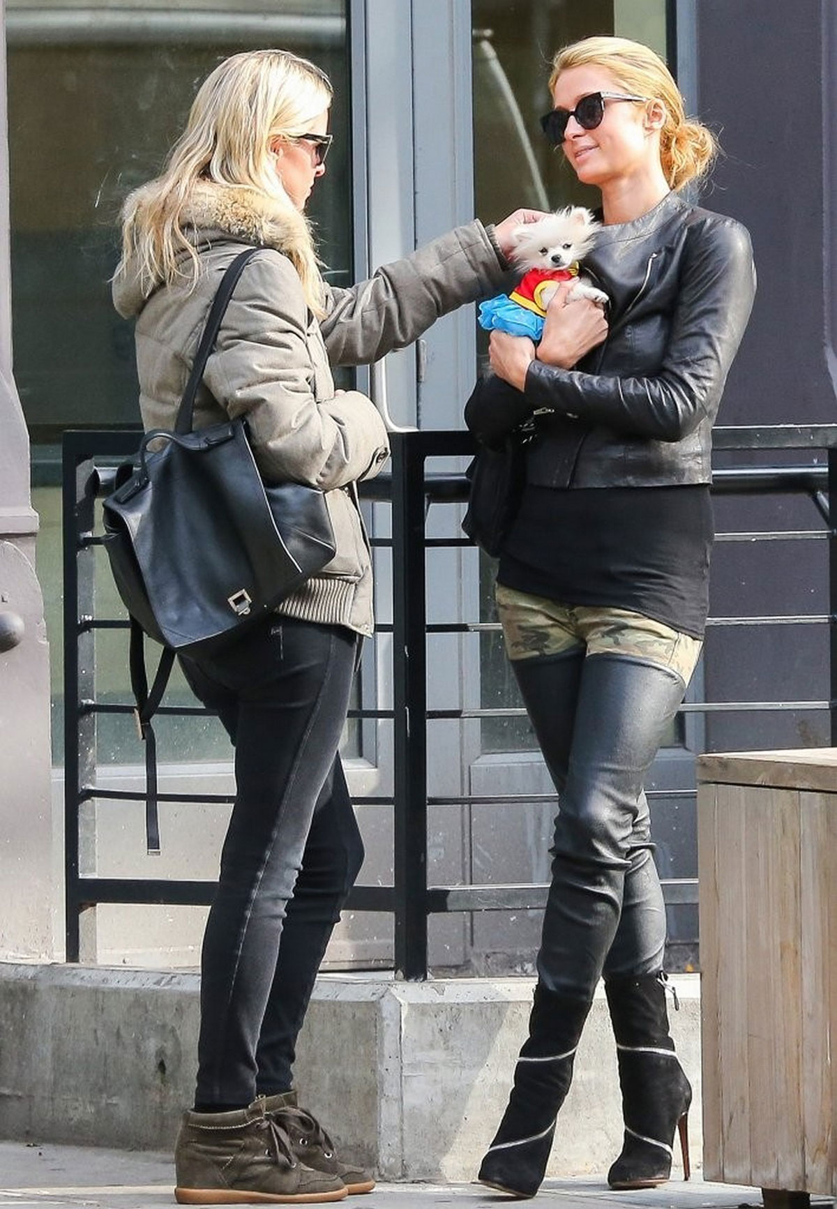 Paris Hilton seen with her dog waiting for a cab