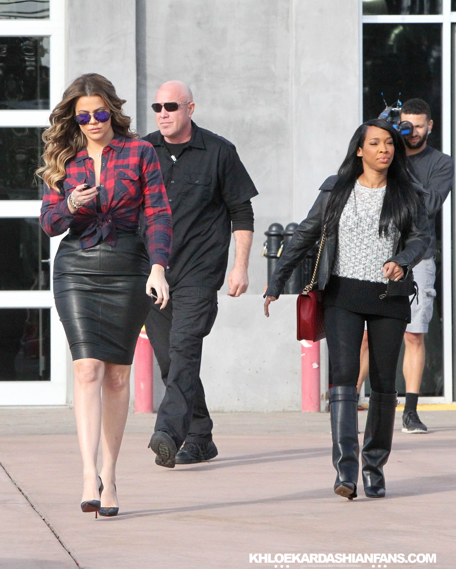 Khloe Kardashian rocks a tight black leather skirt while filming in Calabasas