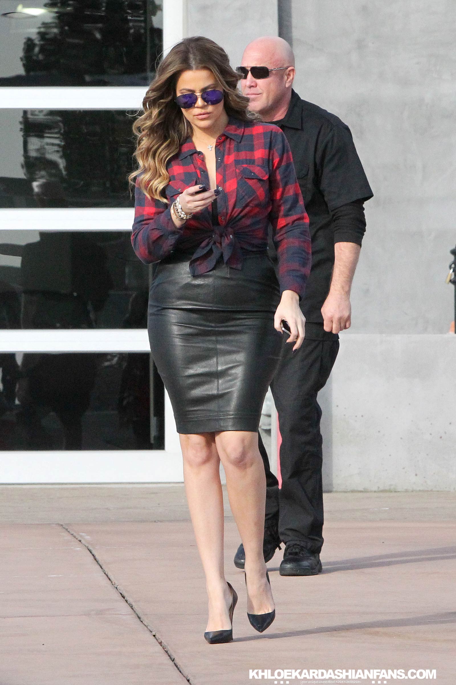 Khloe Kardashian rocks a tight black leather skirt while filming in Calabasas