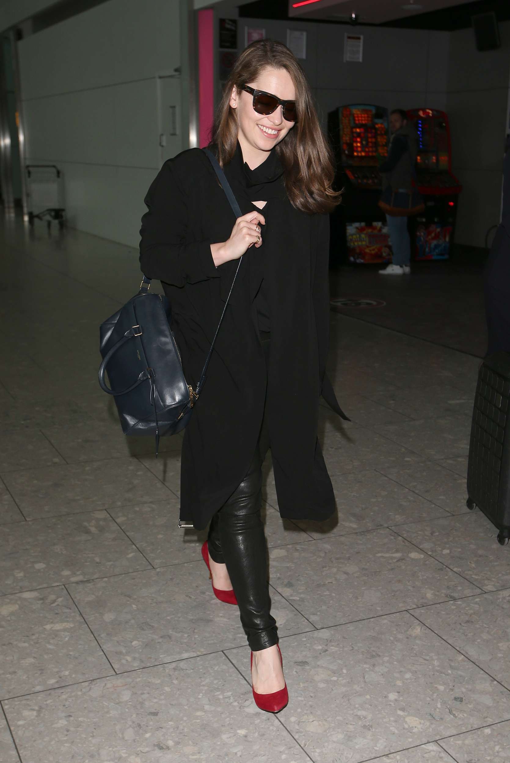 Emilia Clarke Walks through Heathrow Airport