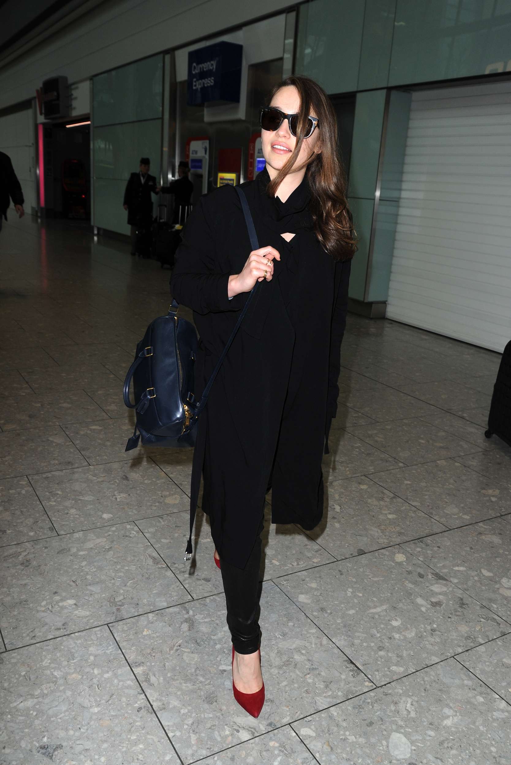Emilia Clarke Walks through Heathrow Airport