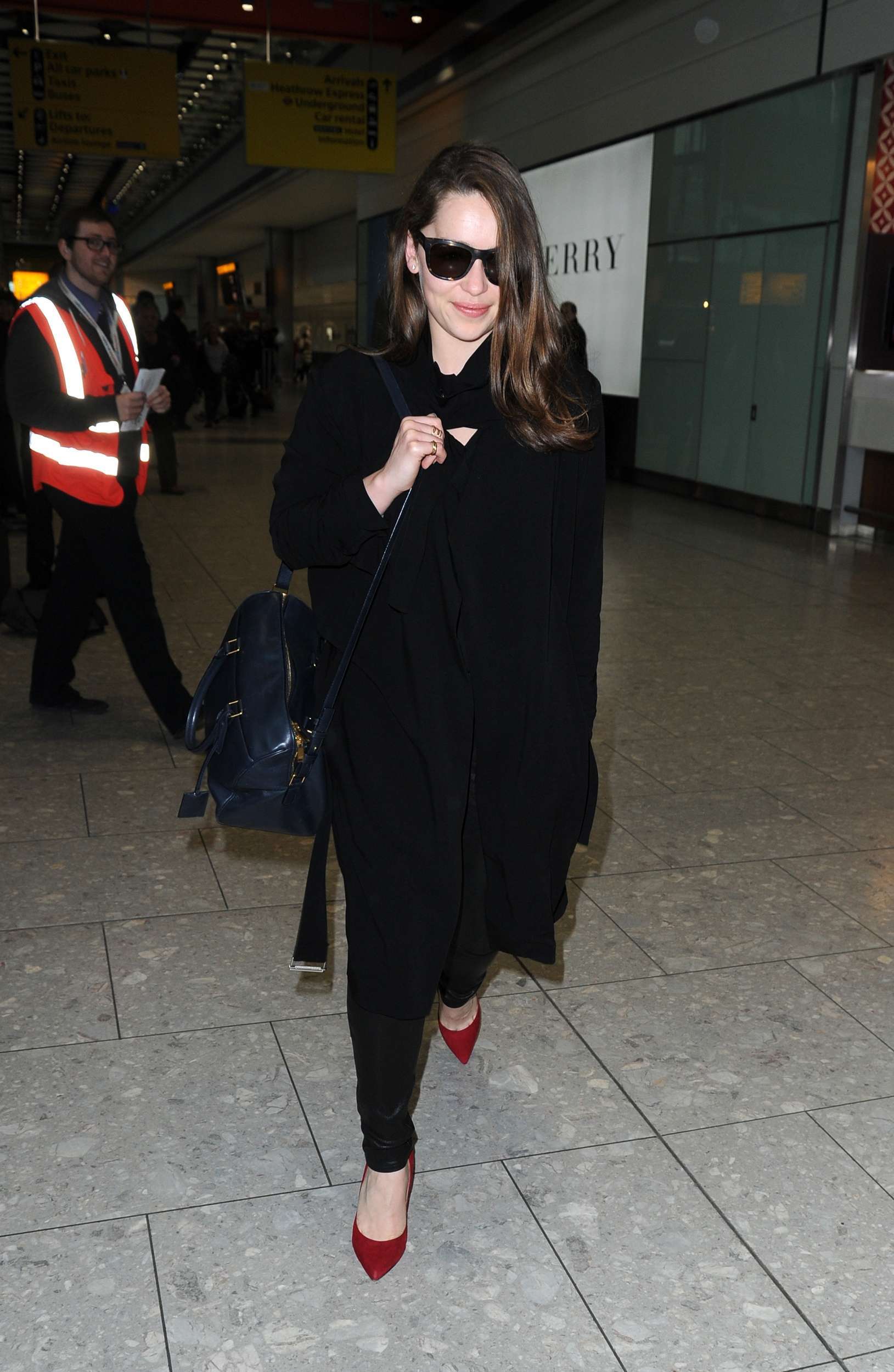 Emilia Clarke Walks through Heathrow Airport