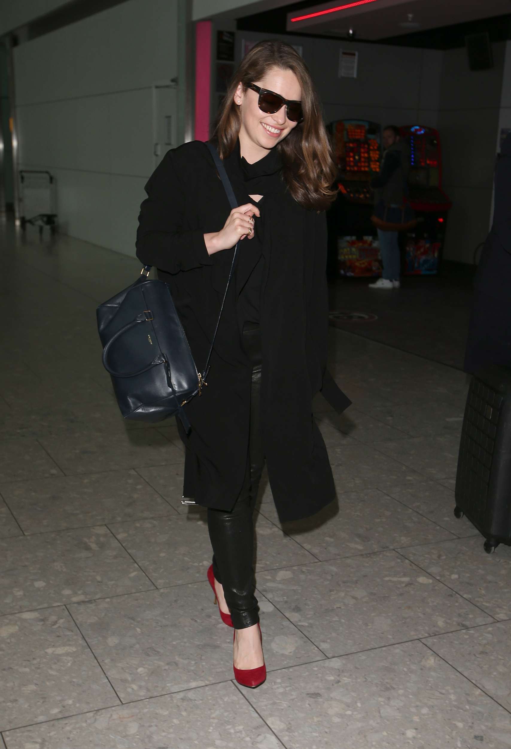 Emilia Clarke Walks through Heathrow Airport