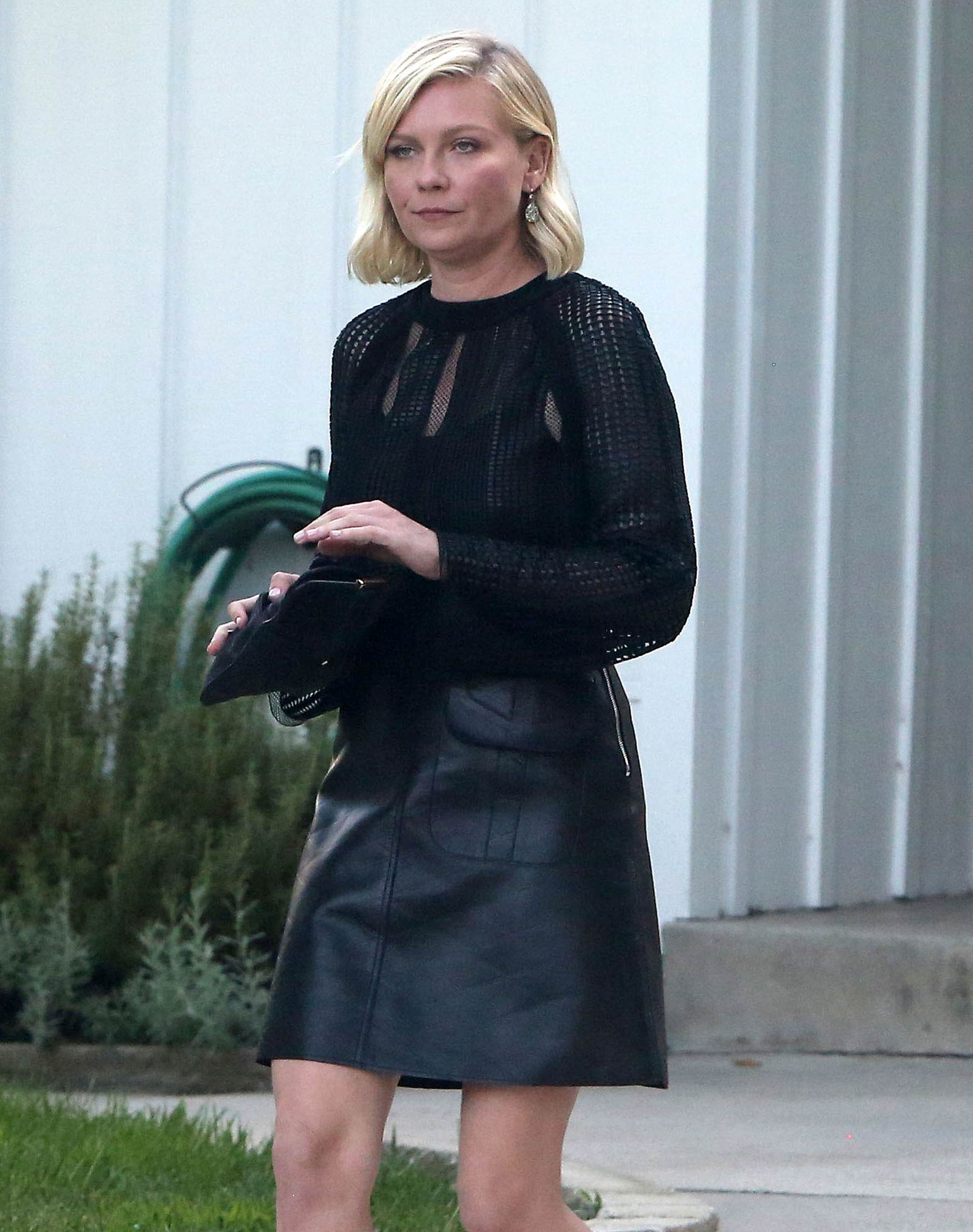Kirsten Dunst getting into a limo outside her house