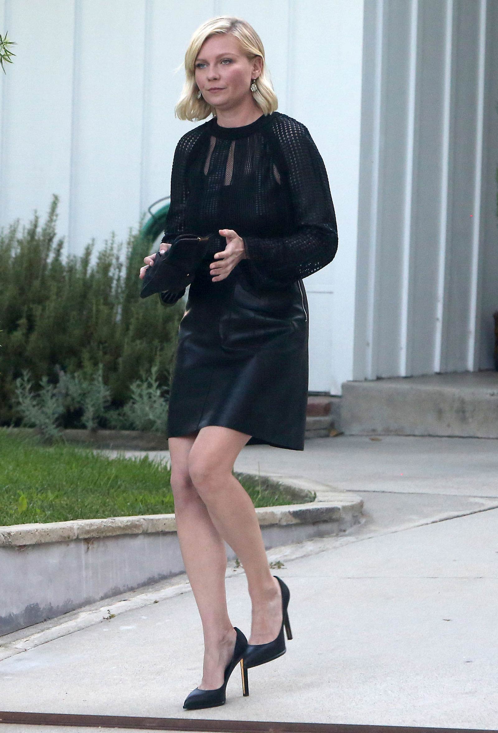 Kirsten Dunst getting into a limo outside her house