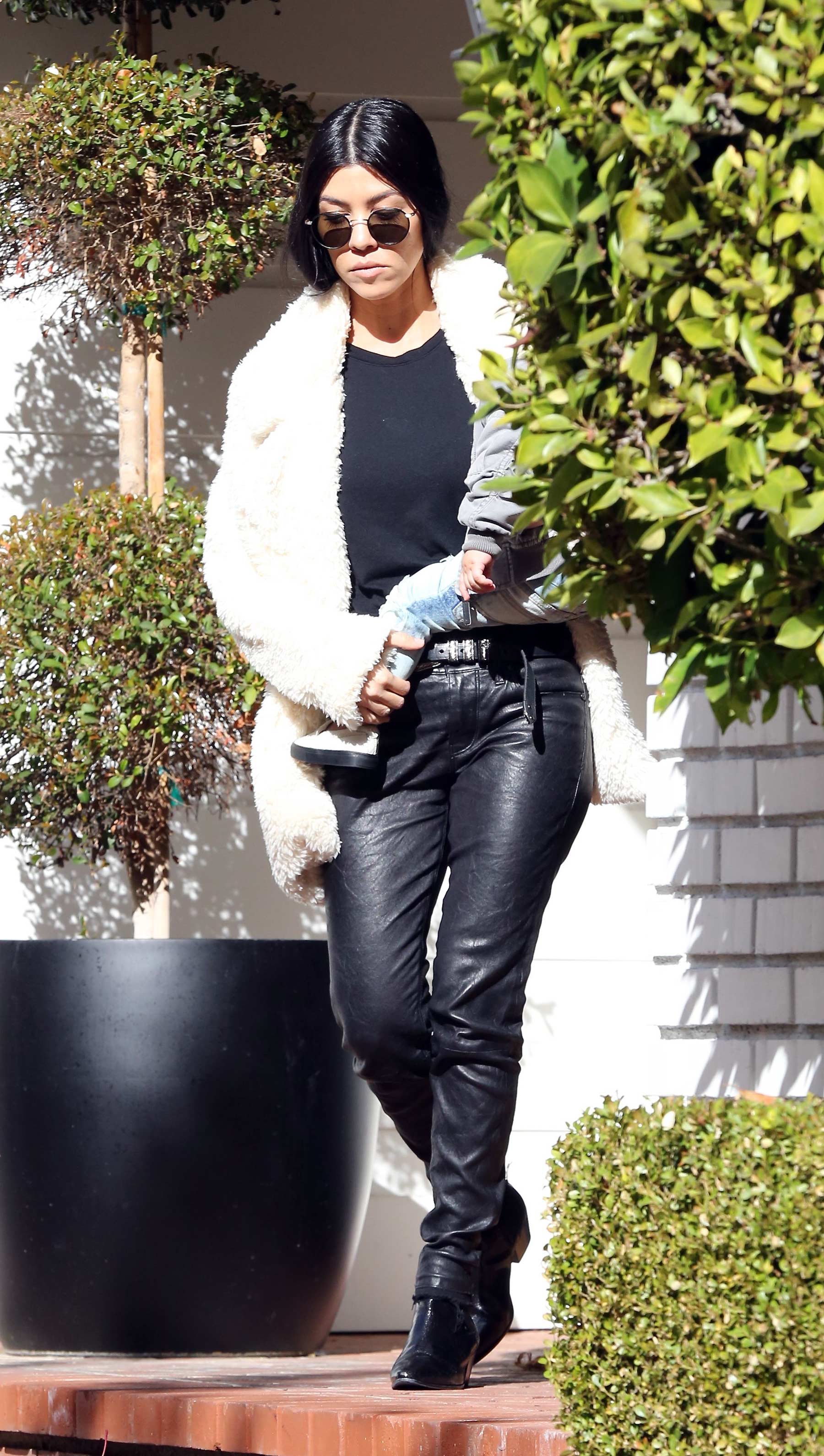 Kourtney Kardashian makes her way out of a building