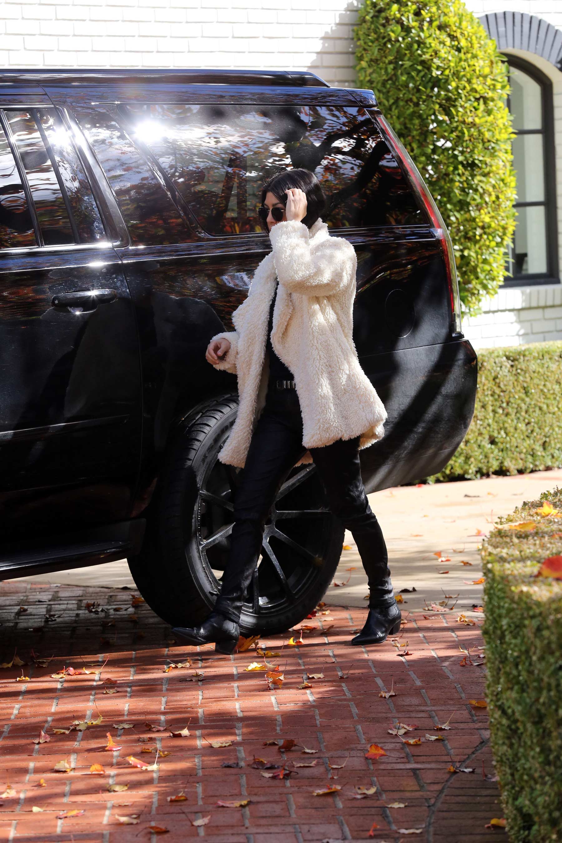 Kourtney Kardashian makes her way out of a building