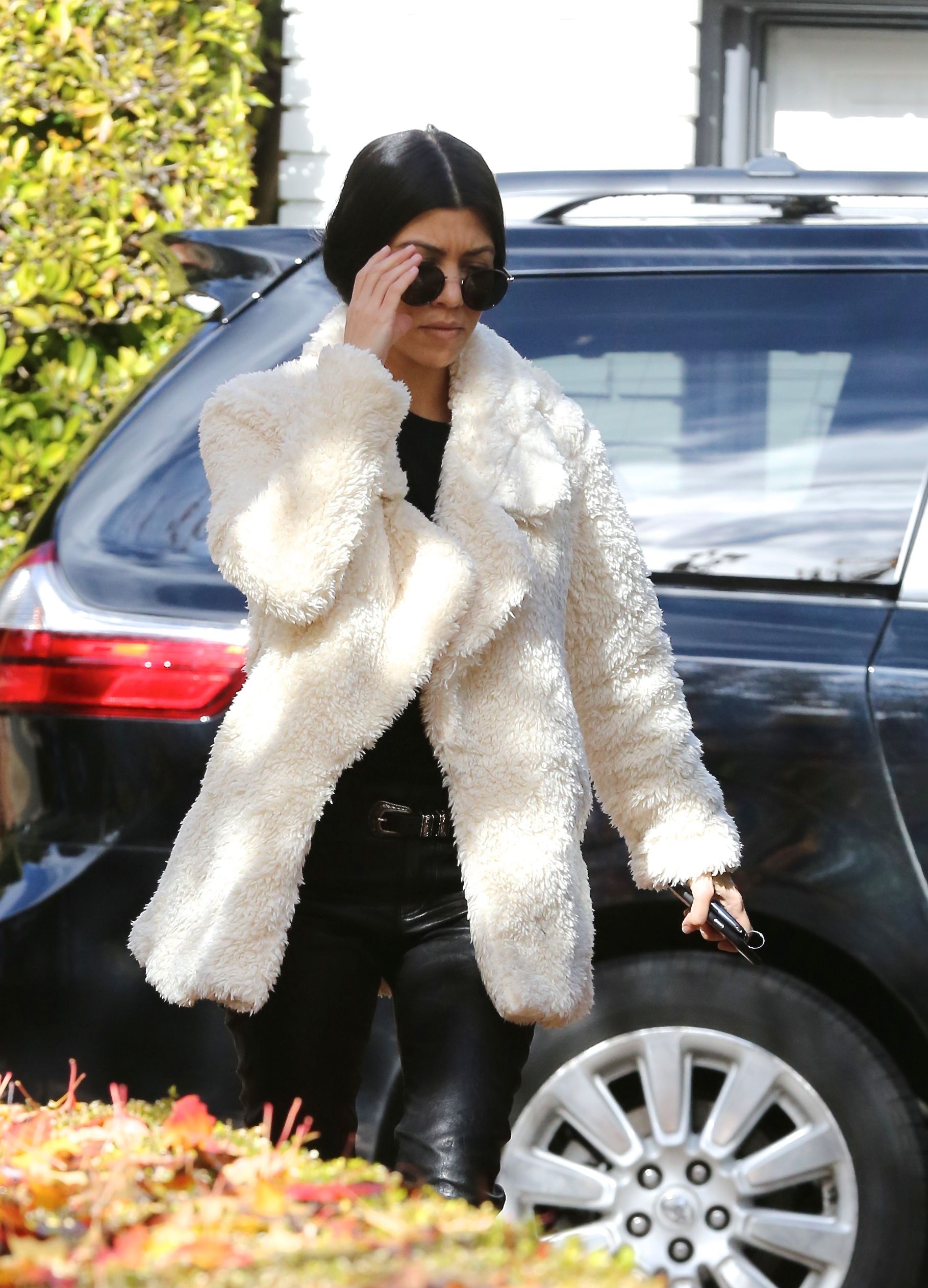 Kourtney Kardashian makes her way out of a building