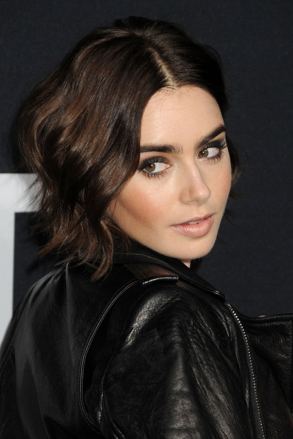 Lily Collins attends Saint Laurent Fashion Show