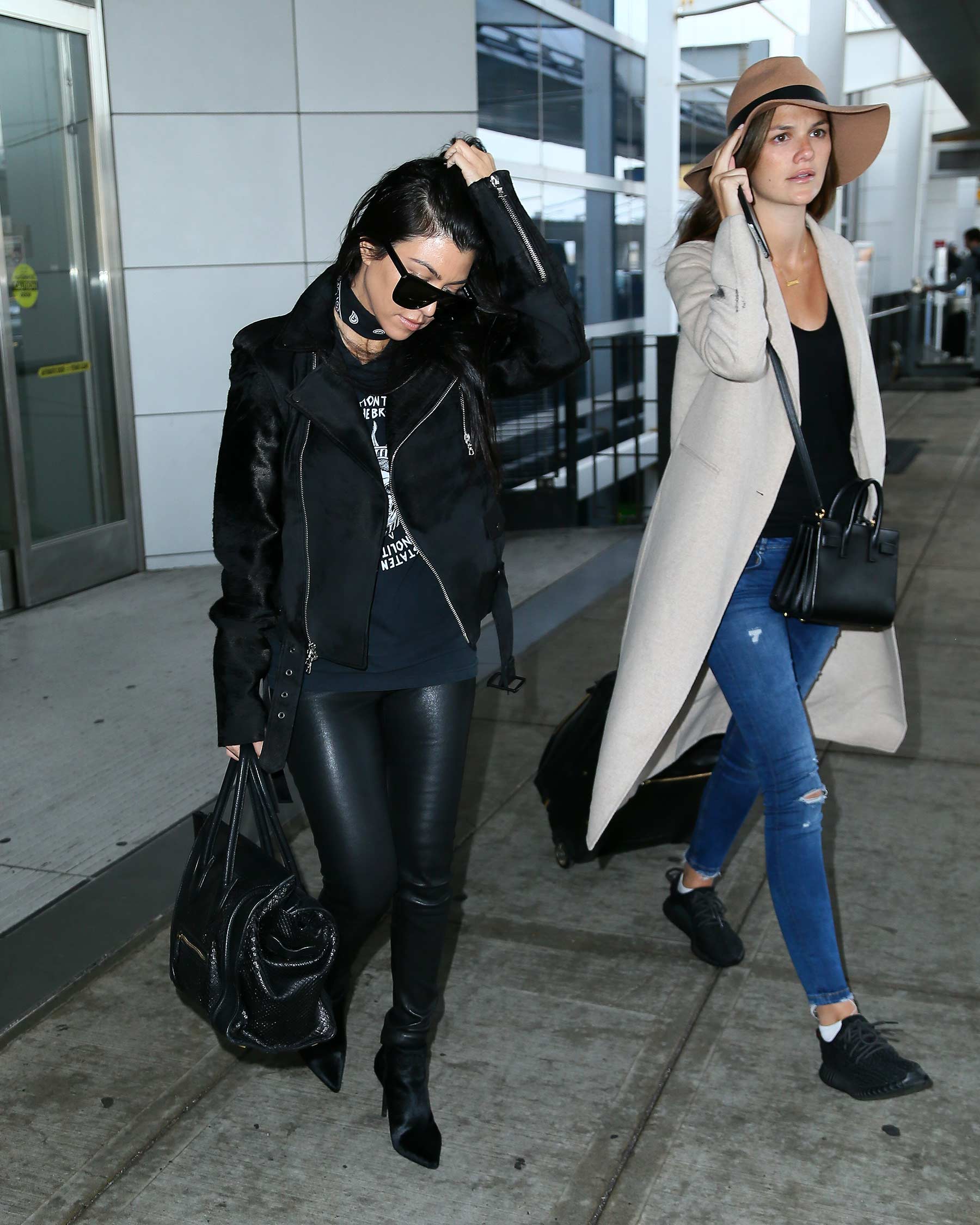 Kourtney Kardashian is seen at LAX and JFK airports