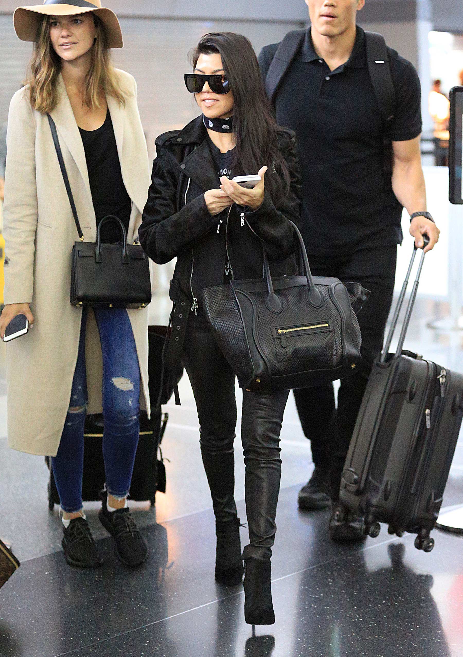 Kourtney Kardashian is seen at LAX and JFK airports