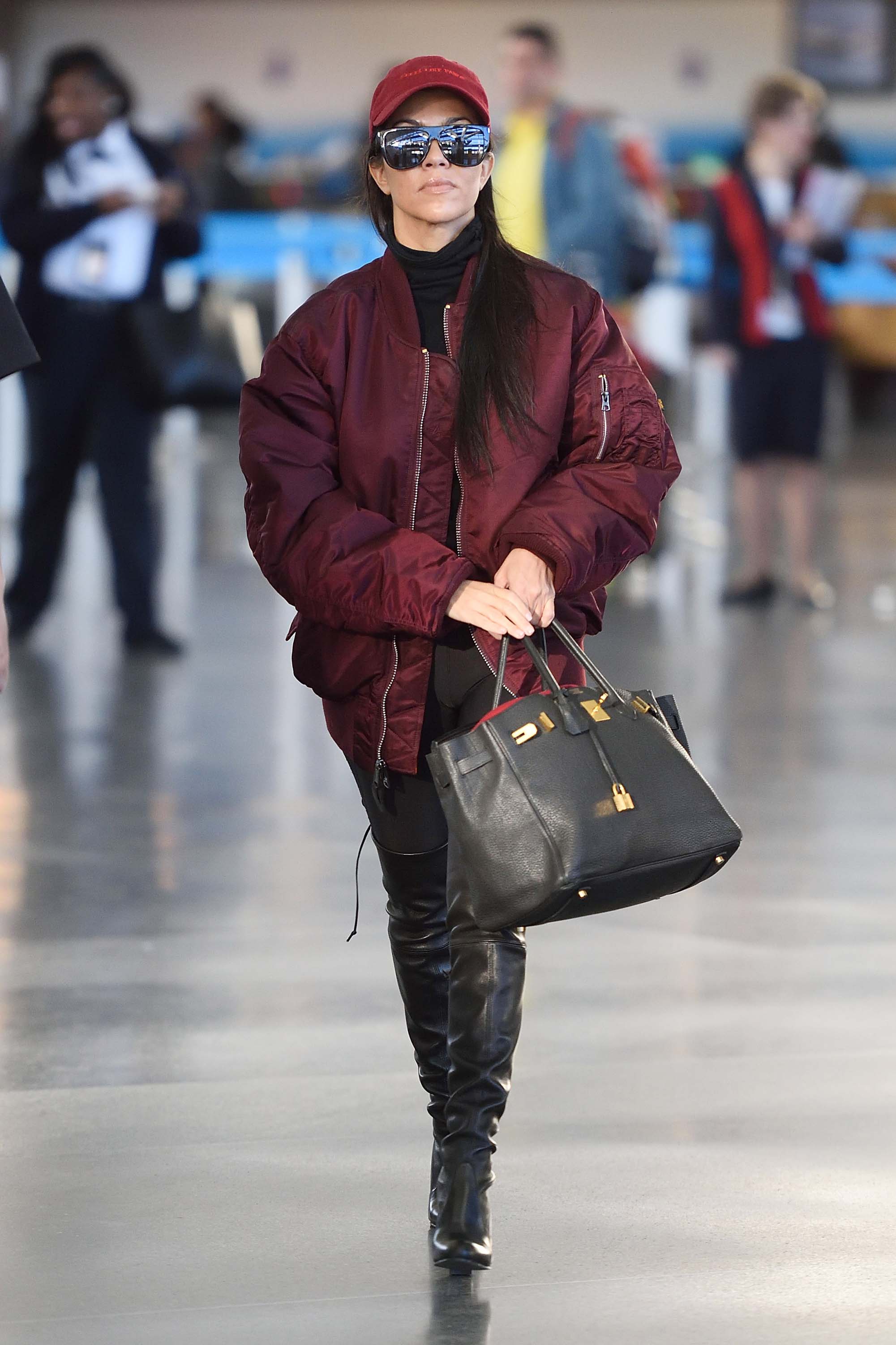 Kourtney Kardashian making her way through JFK airport