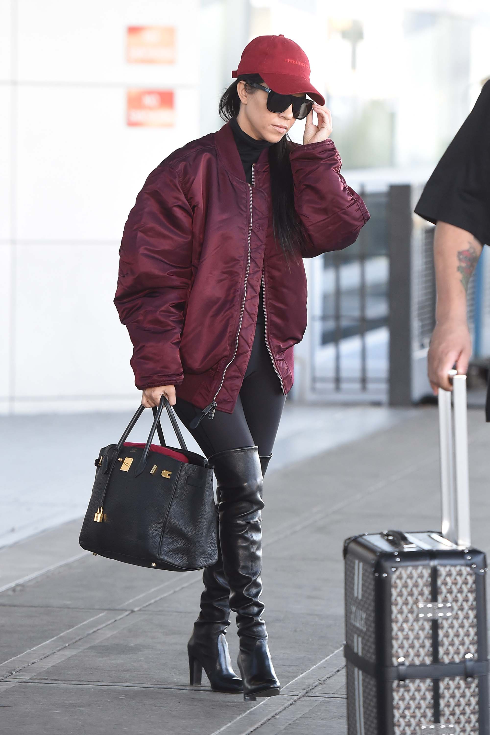 Kourtney Kardashian making her way through JFK airport