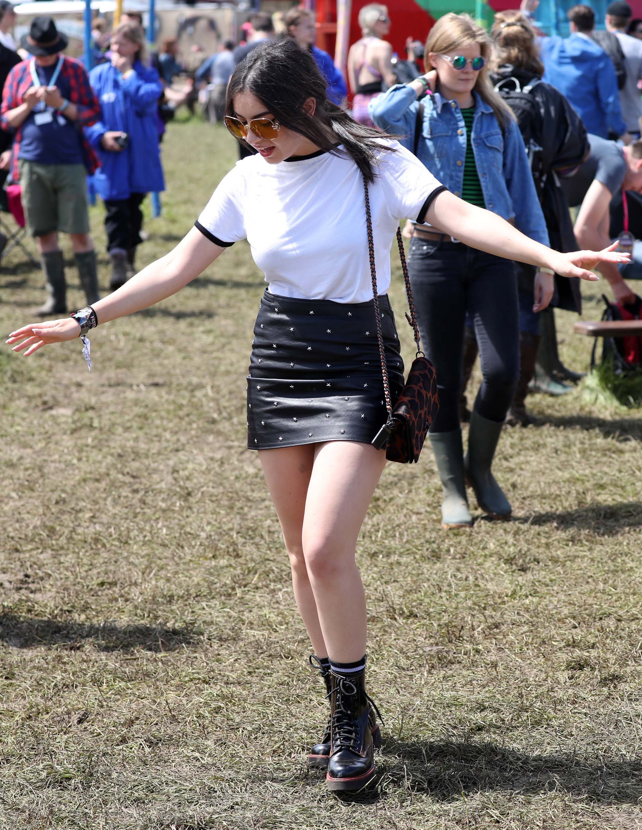 Charlie XCX wearing Coach attends the Glastonbury Festival