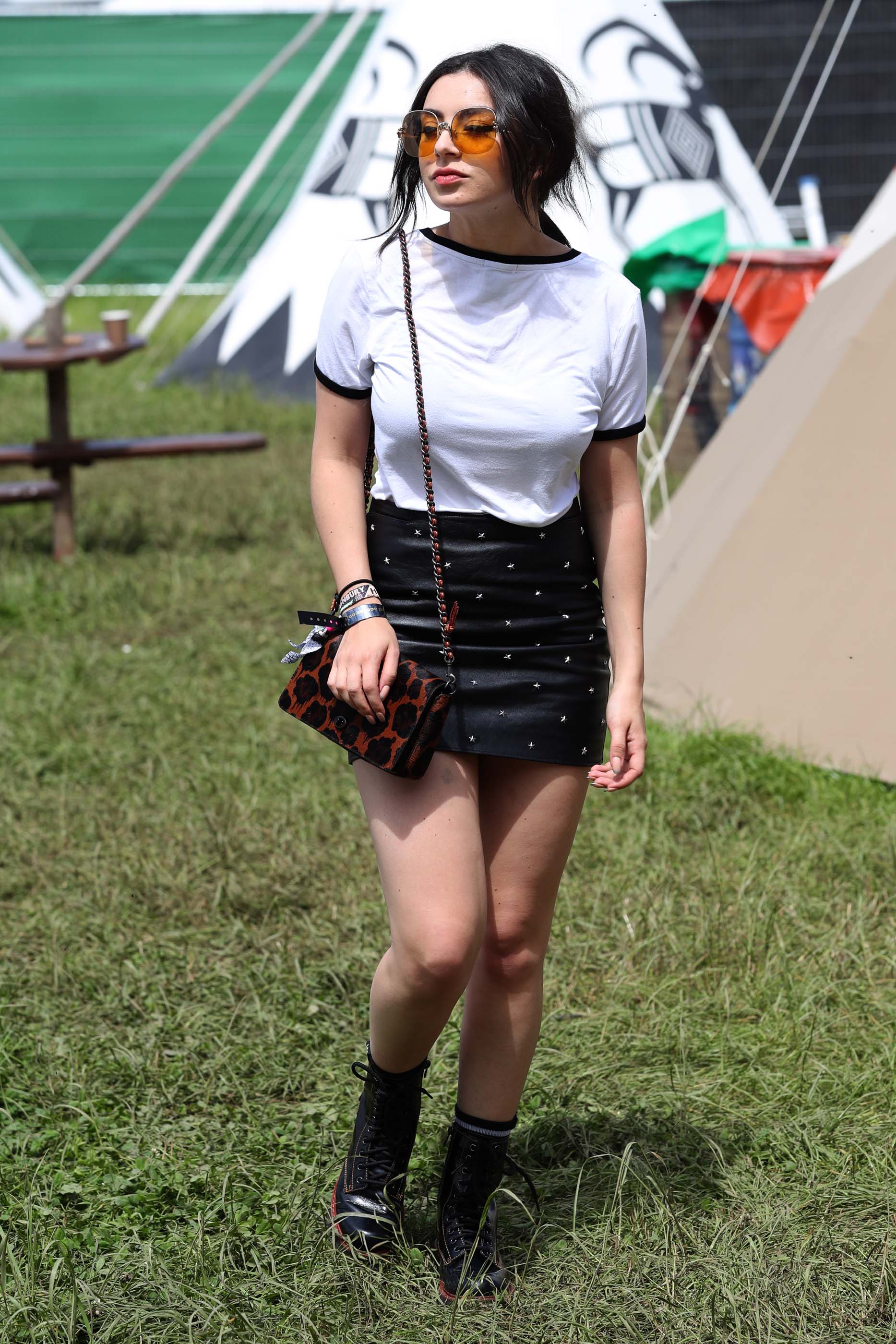 Charlie XCX wearing Coach attends the Glastonbury Festival