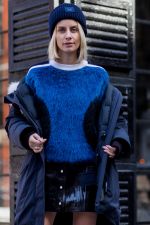 Lisa Hahnbueck wearing beanie, Louis Vuitton bag, blue orange