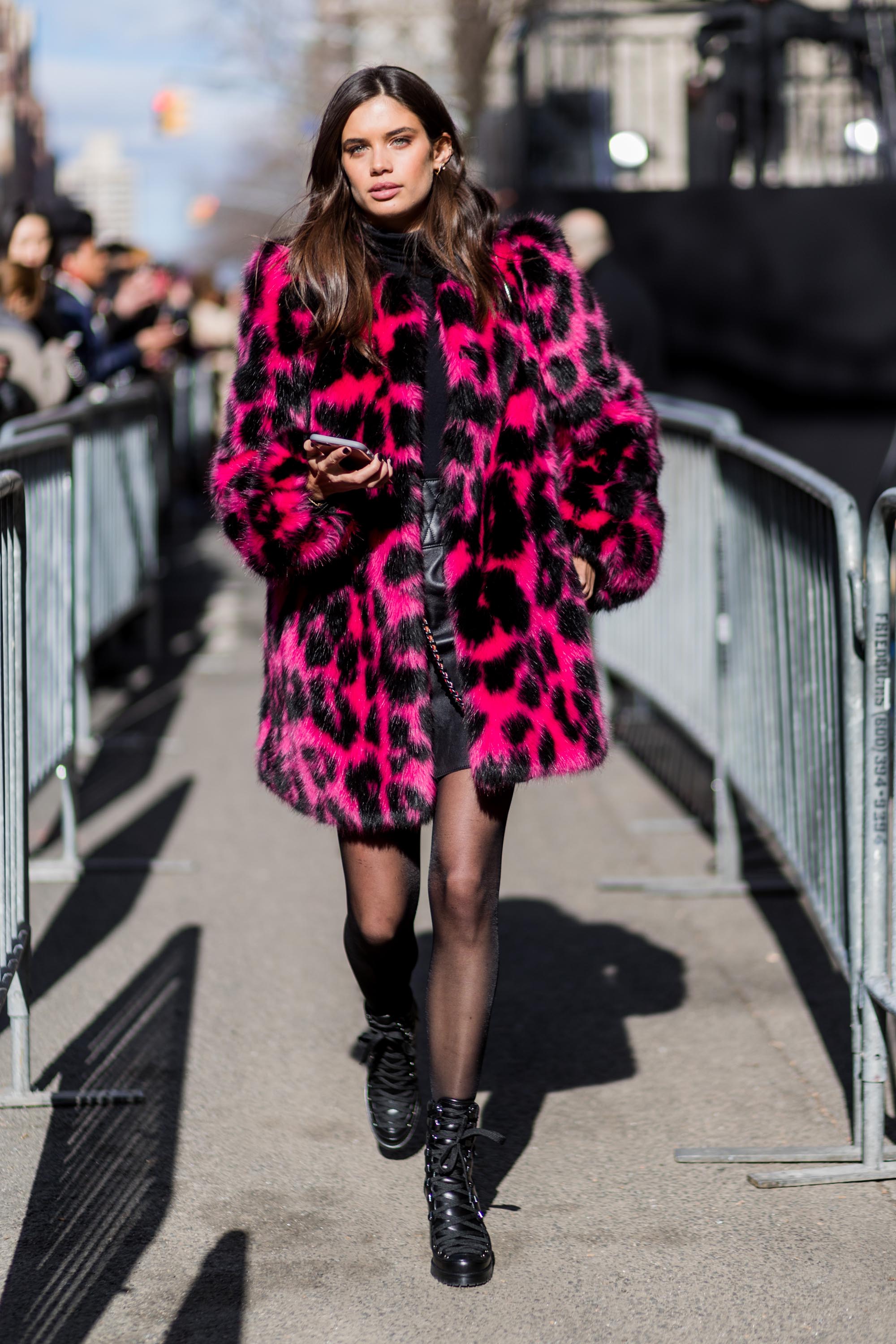 Sara Sampaio wearing a pink black leoprint coat outside Marc Jacobs