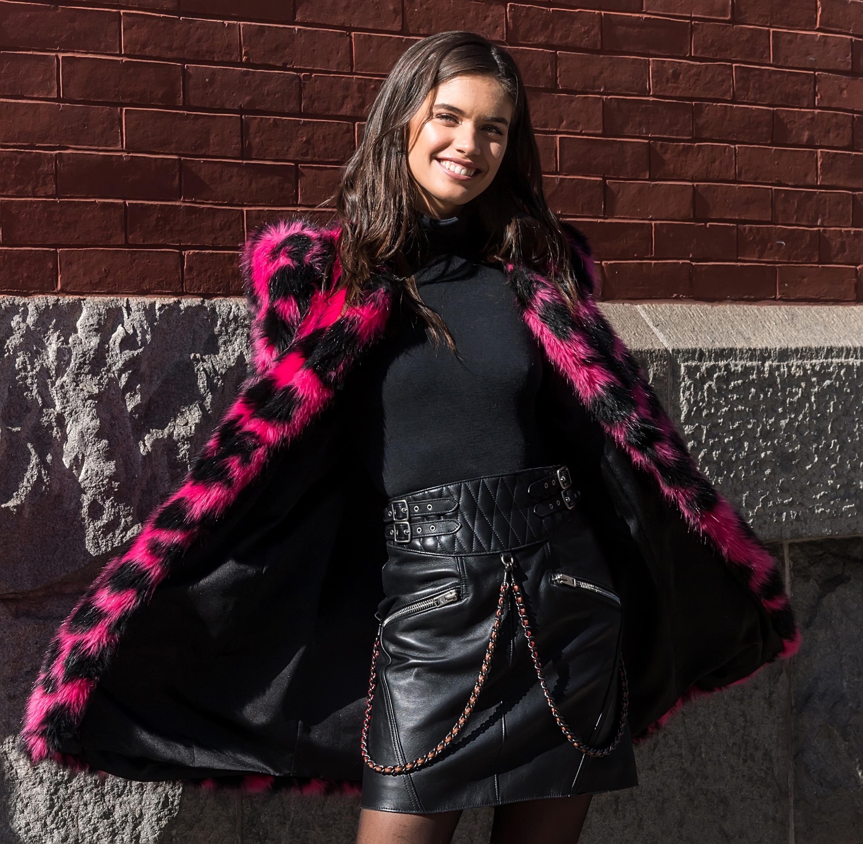 Sara Sampaio wearing a pink black leoprint coat outside Marc Jacobs