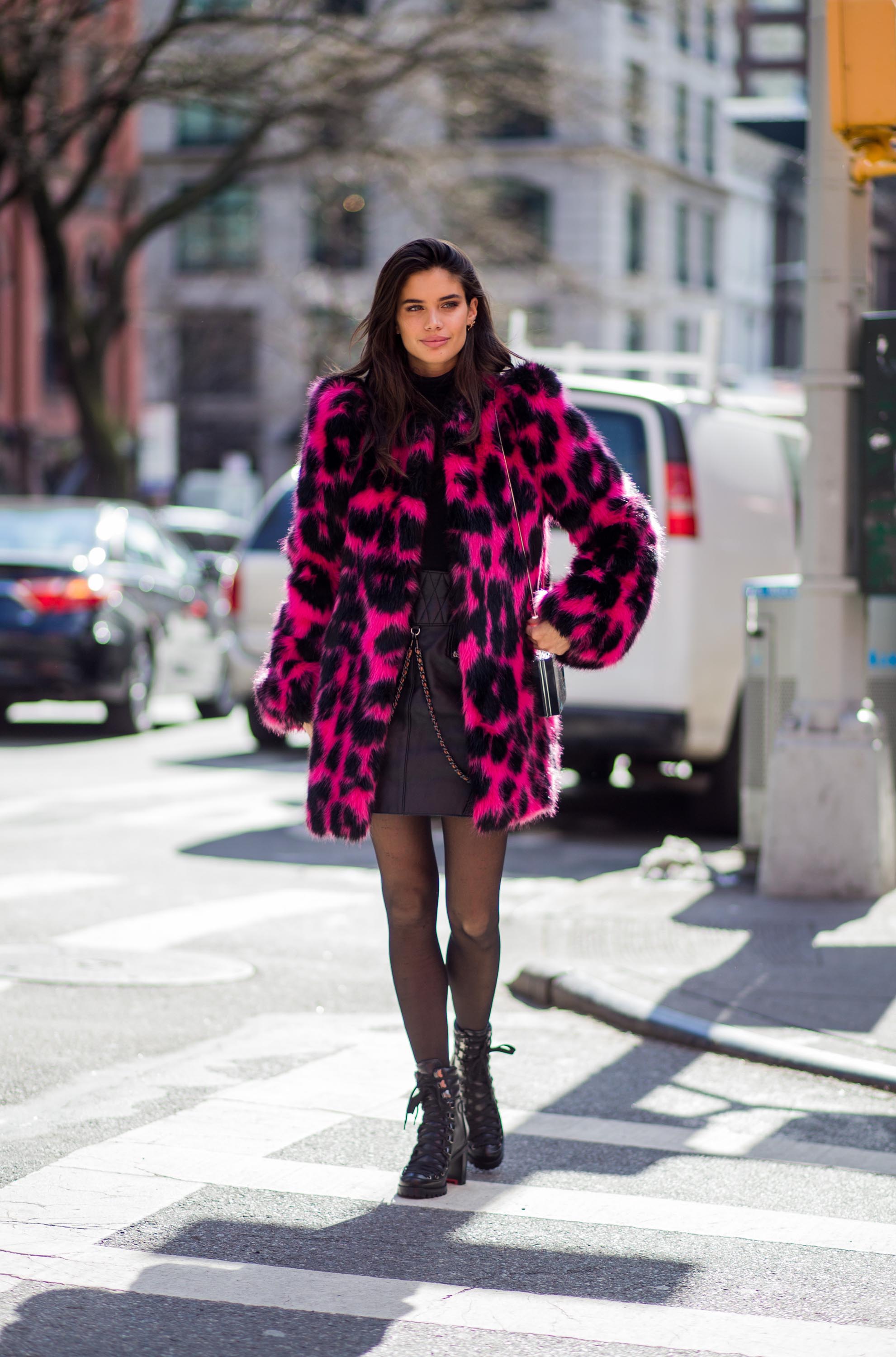 Sara Sampaio wearing a pink black leoprint coat outside Marc Jacobs