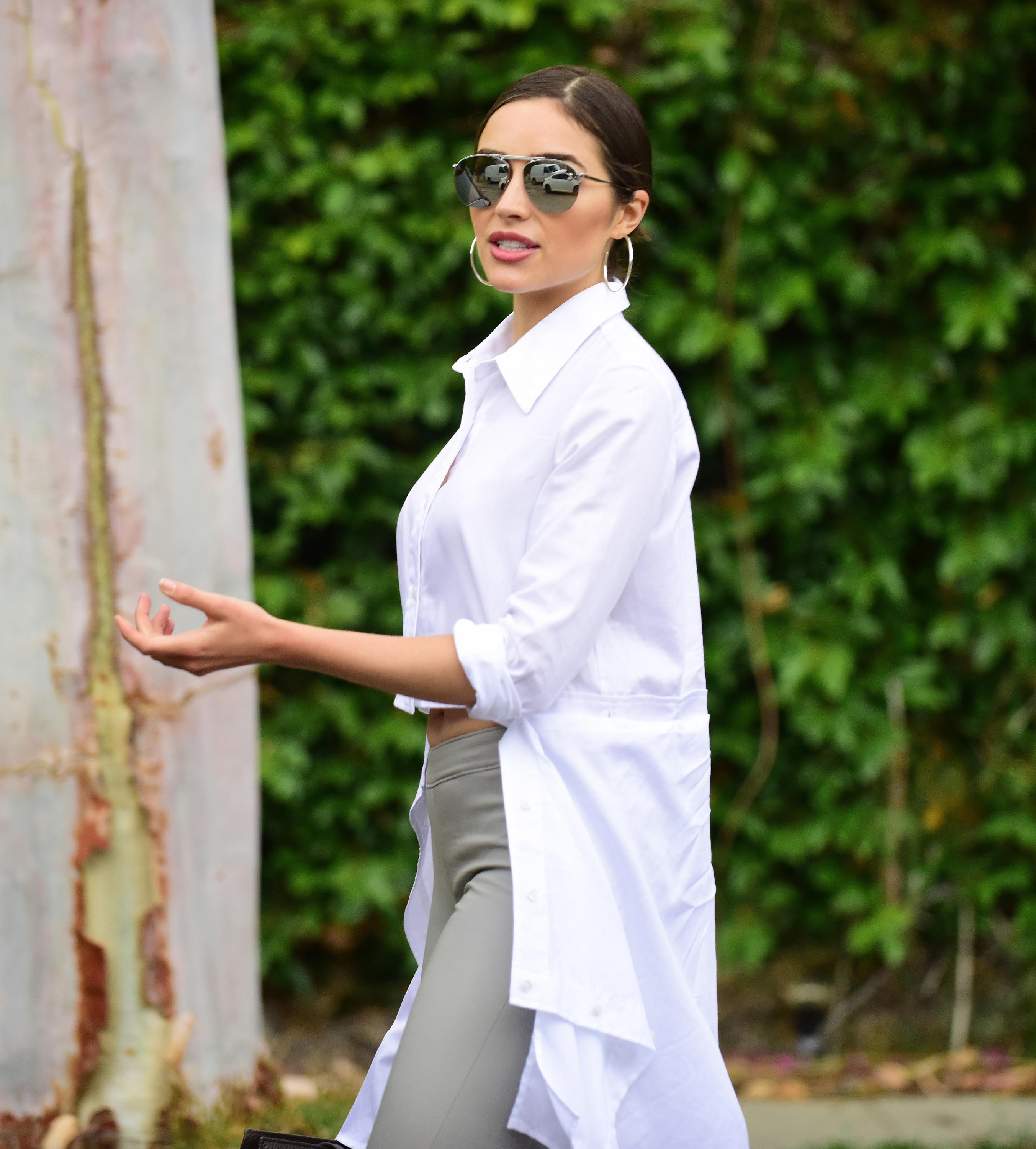 Olivia Culpo poses on set of a photoshoot