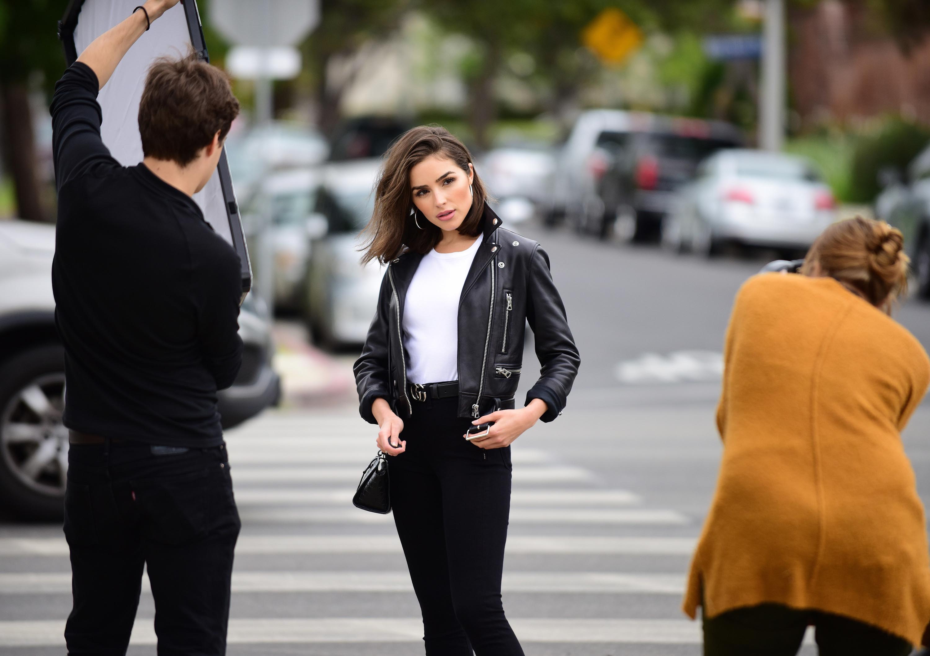 Olivia Culpo poses on set of a photoshoot