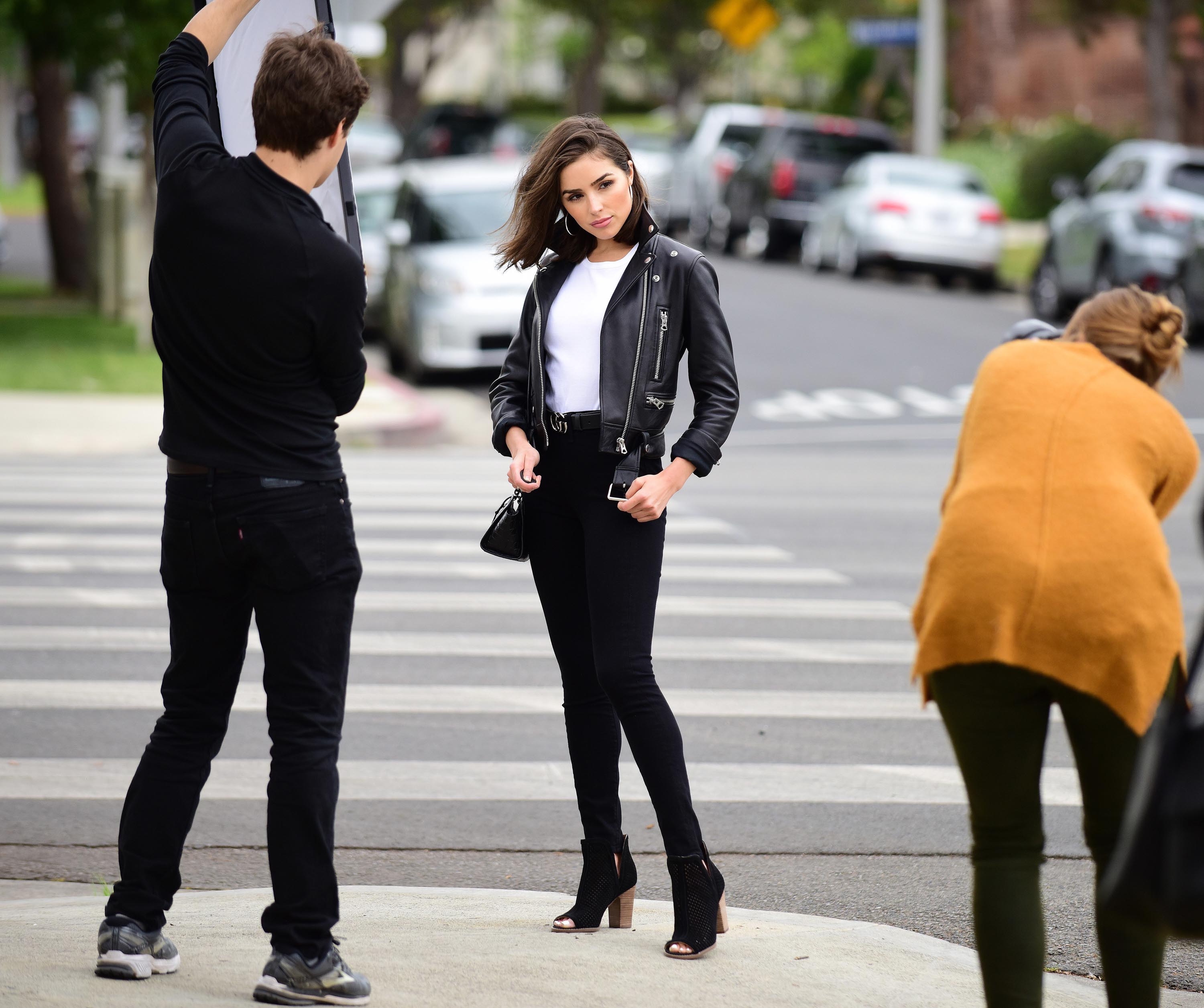 Olivia Culpo poses on set of a photoshoot