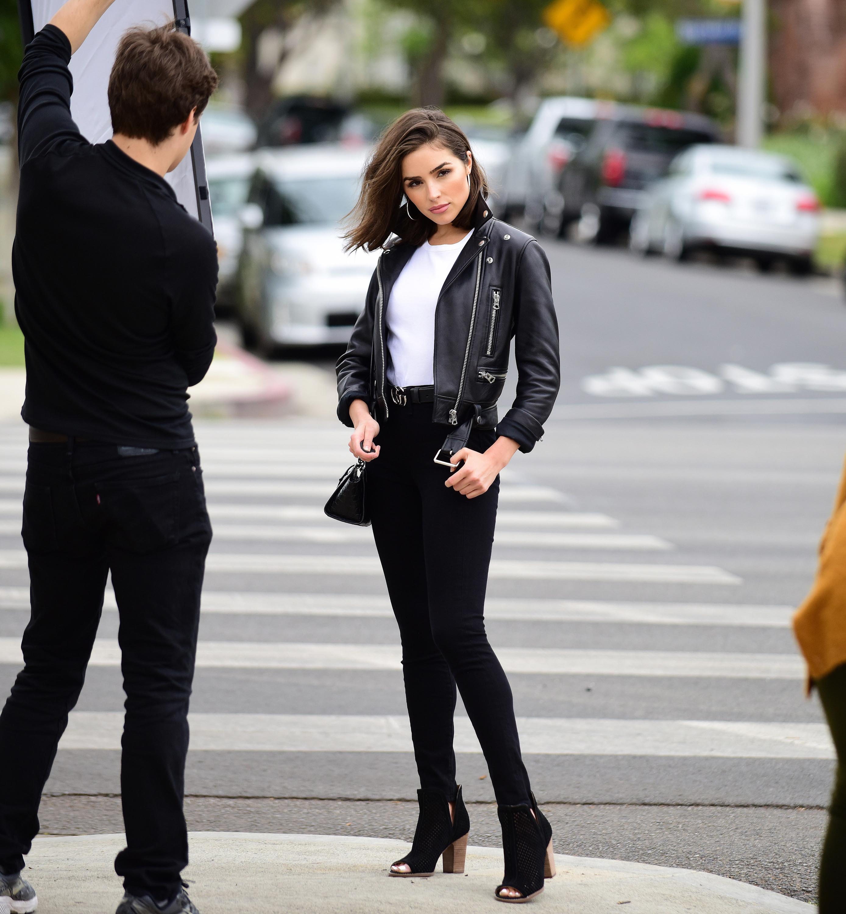 Olivia Culpo poses on set of a photoshoot