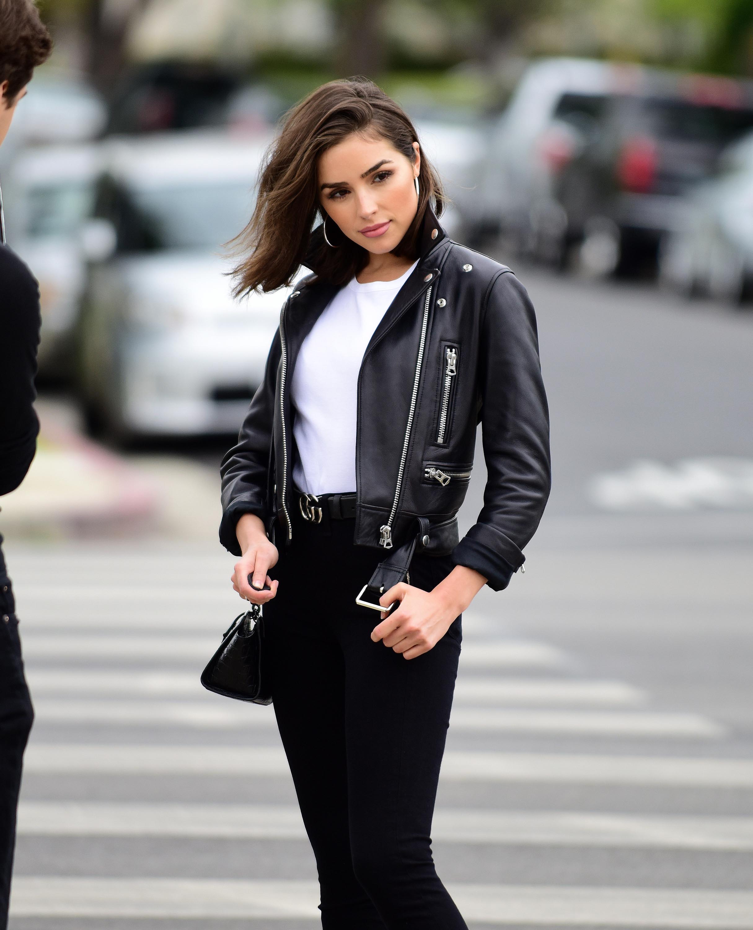 Olivia Culpo poses on set of a photoshoot